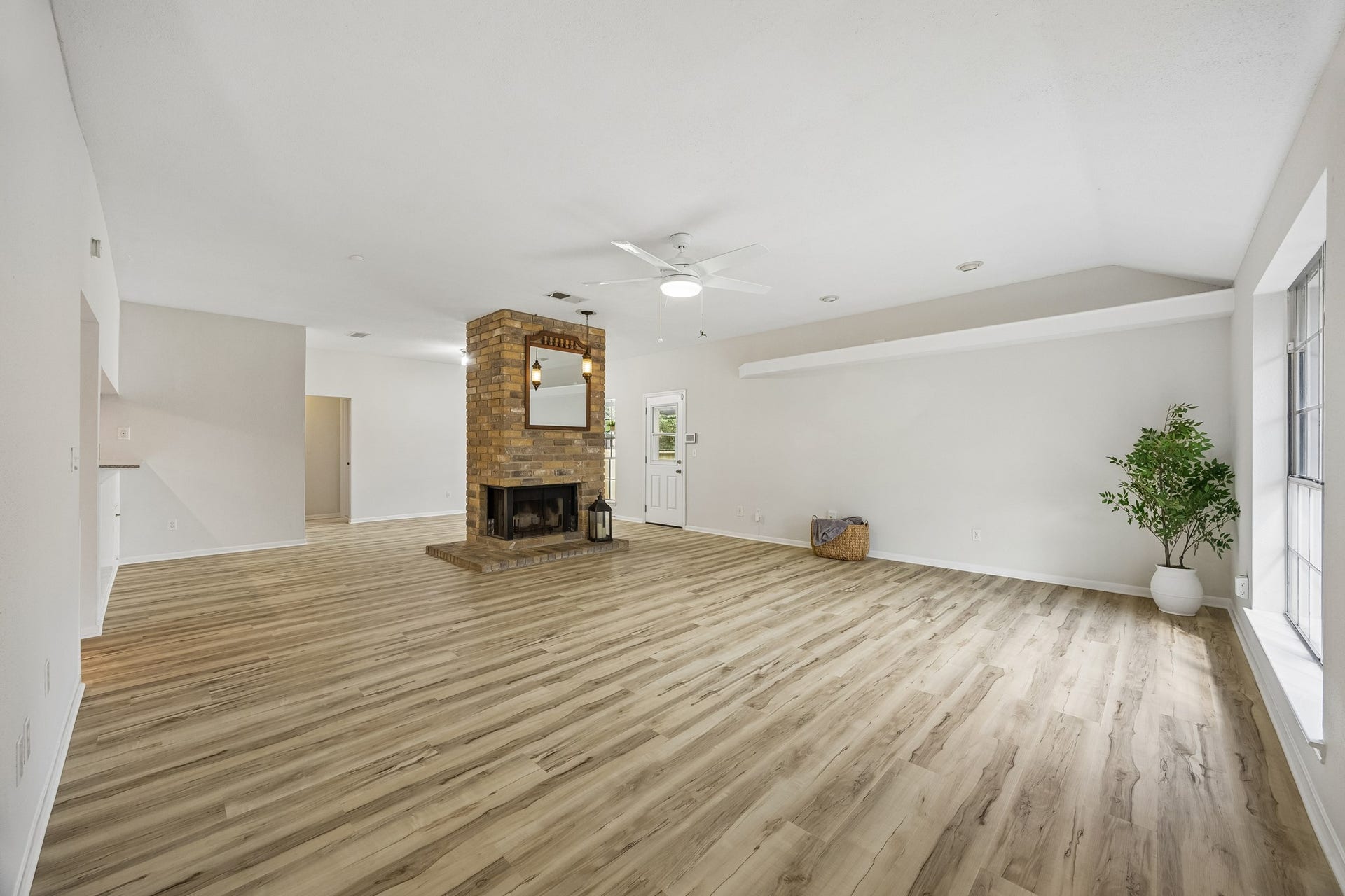 2716 Village Mills Drive, Pearland, TX 77584 Spacious den and formai dining separated by fireplace.