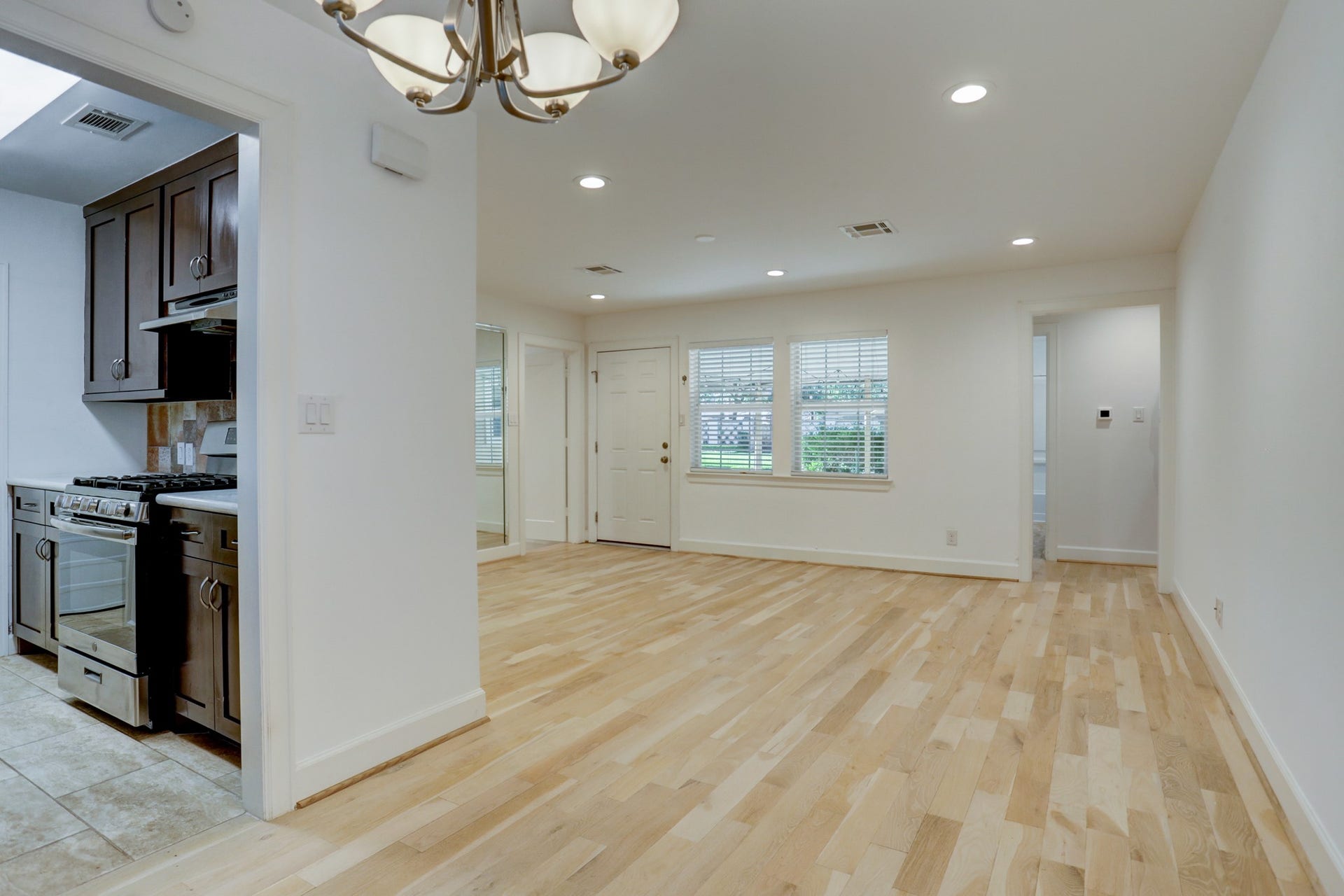 4419 Cynthia, Bellaire, TX 77401 Standing in the dining room, view of the kitchen, entrance, living room, & the hallway to the bedrooms. Look at the gorgeous hardwood floor.