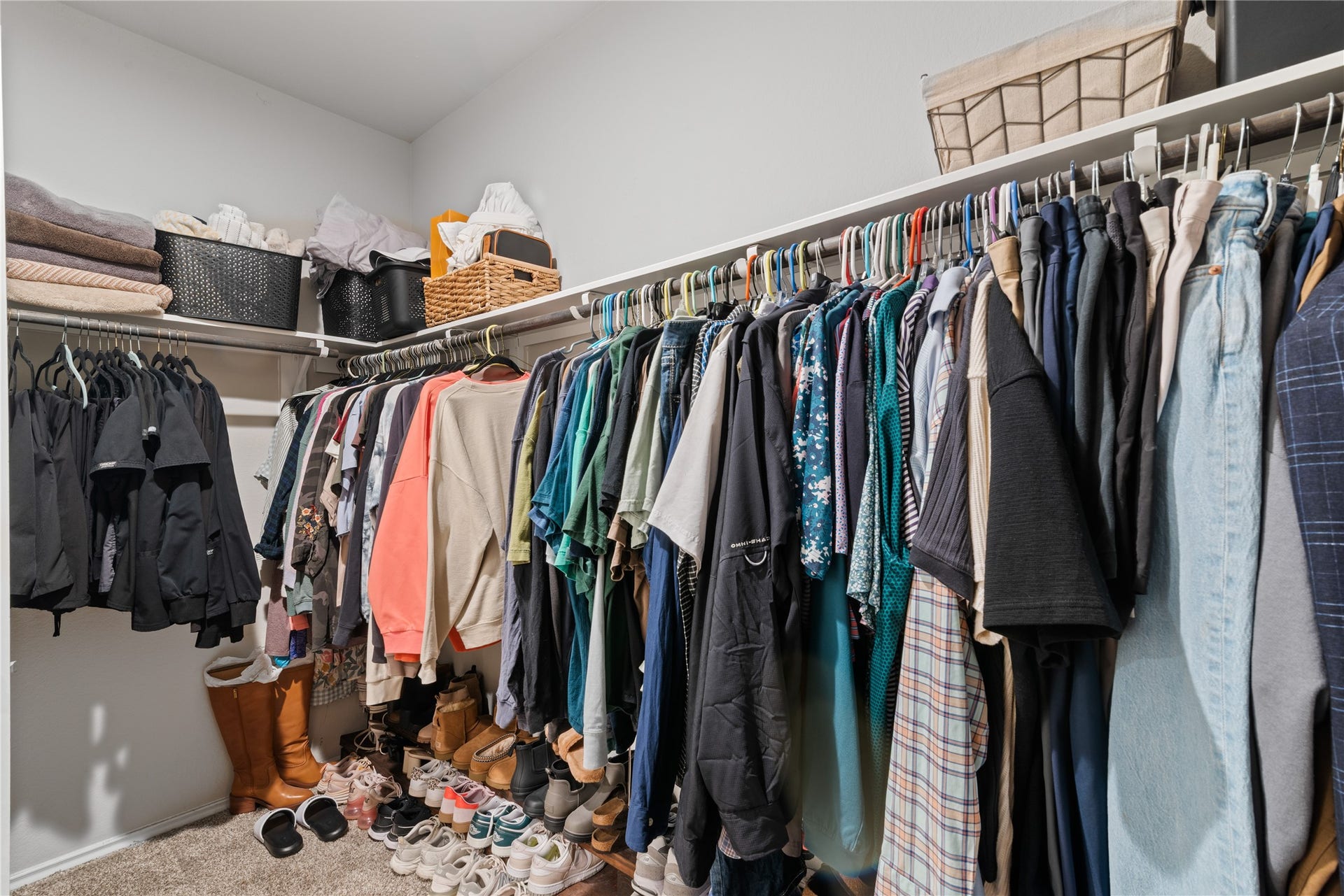 Spacious walk-in closet with ample shelving, organized clothing racks, and convenient shoe storage.