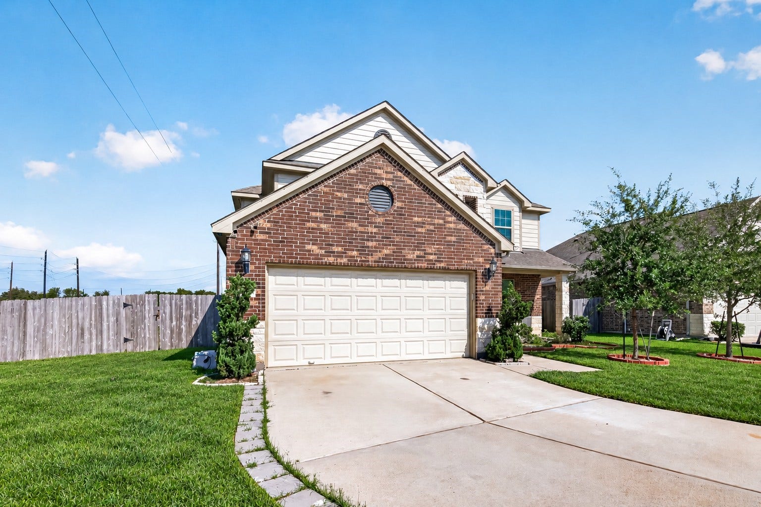 3658 Diamond Creek Drive, Missouri City, TX 77459 Alternate exterior view highlighting the home's brick faade, driveway, and generous front lawn. Mature landscaping adds to the curb appeal.