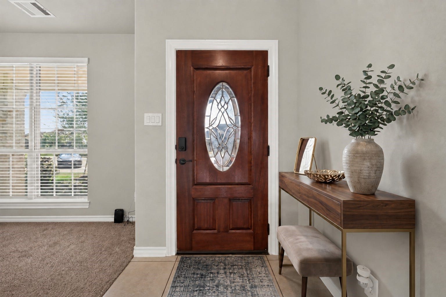3658 Diamond Creek Drive, Missouri City, TX 77459 Virtually staged. Inviting entry with natural light and a warm wood front door. A welcoming introduction to the home's interior.