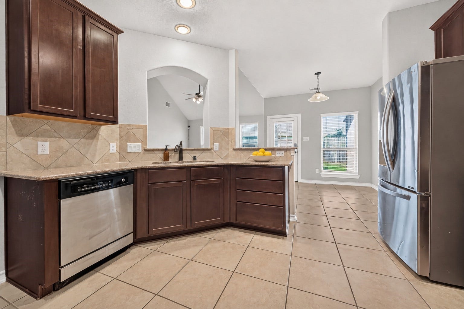 3658 Diamond Creek Drive, Missouri City, TX 77459 Spacious kitchen offers generous cabinetry and counter space with a functional layout. Stainless steel appliances complement the warm wood finishes.