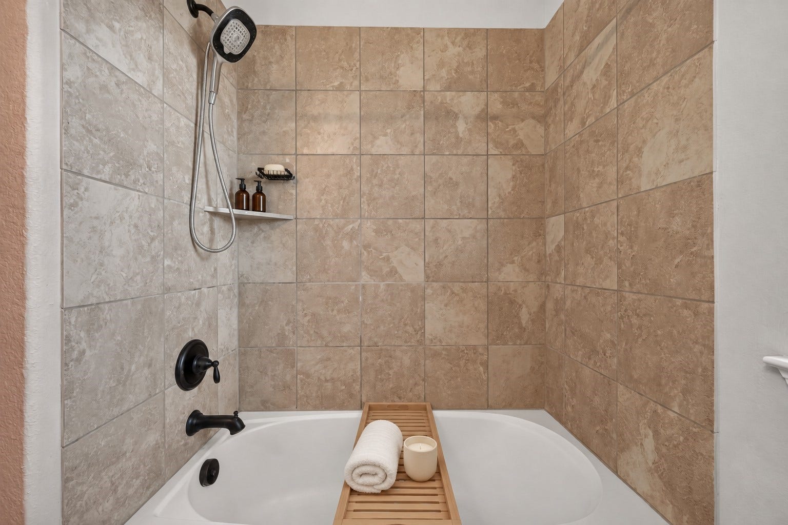 3658 Diamond Creek Drive, Missouri City, TX 77459 Secondary bath features a tiled tub and shower combination with built-in storage niche. Neutral tile creates a clean and functional finish.