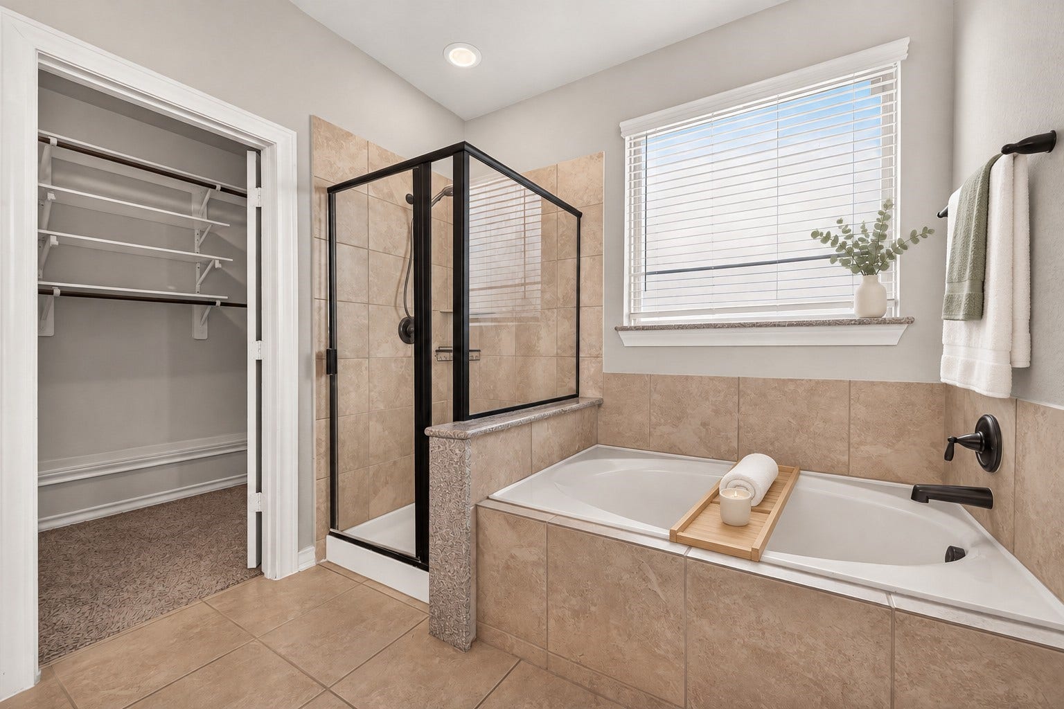 3658 Diamond Creek Drive, Missouri City, TX 77459 Primary bath includes a separate tub and glass-enclosed shower. A nearby window brings natural light into the space.