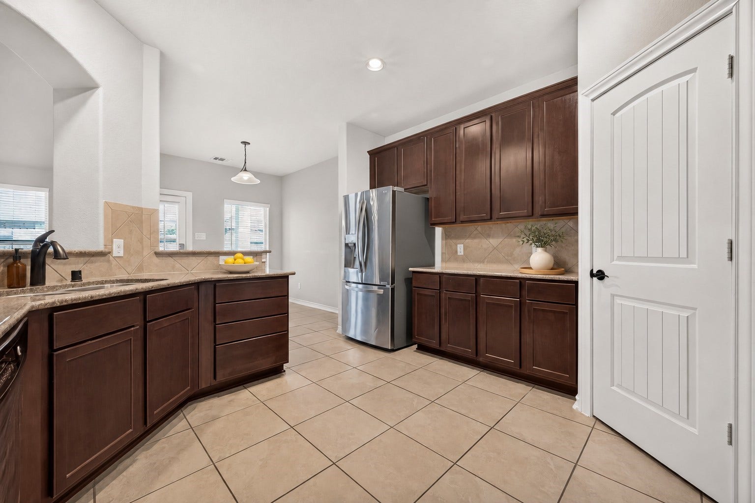 3658 Diamond Creek Drive, Missouri City, TX 77459 Another kitchen view highlighting the abundant cabinetry, pantry access, and connection to the adjoining dining area. A practical layout for everyday use.