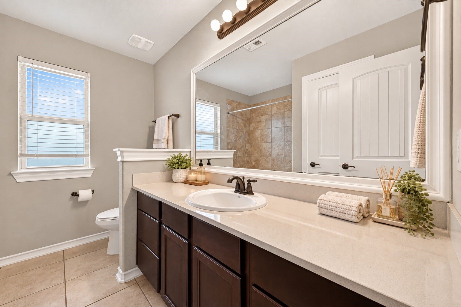 3658 Diamond Creek Drive, Missouri City, TX 77459 Secondary bathroom features an extended vanity with ample counter and storage space. A window brings additional natural light into the room.