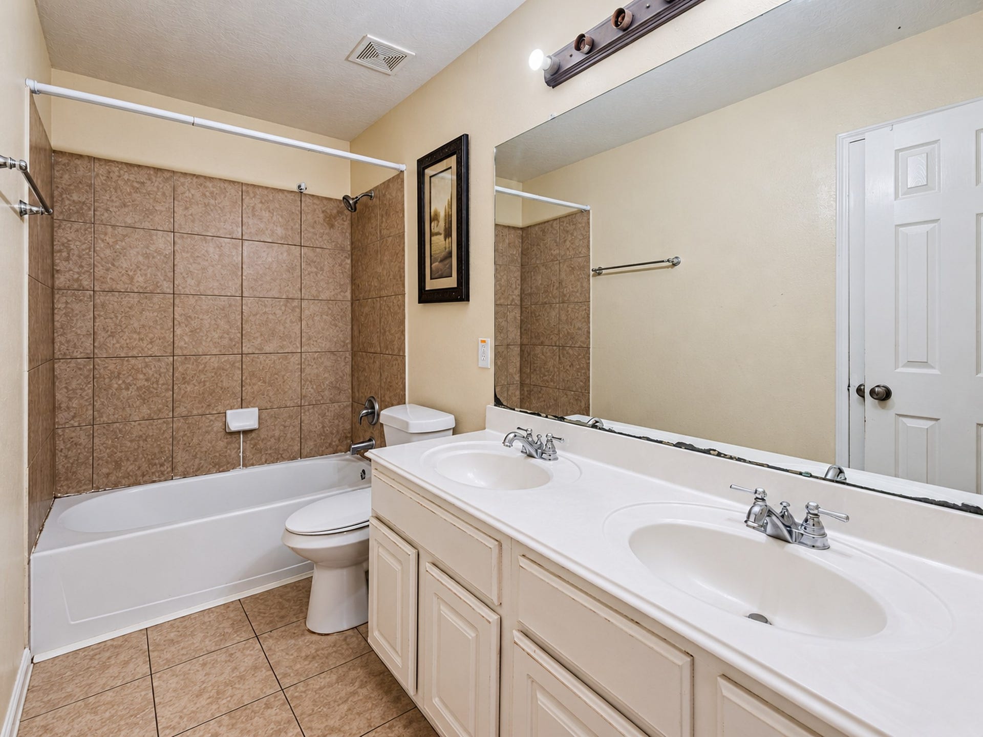 12906 Brook Arbor Court, Pearland, TX 77584 The secondary bathroom features a double-sink vanity and a tub/shower combination