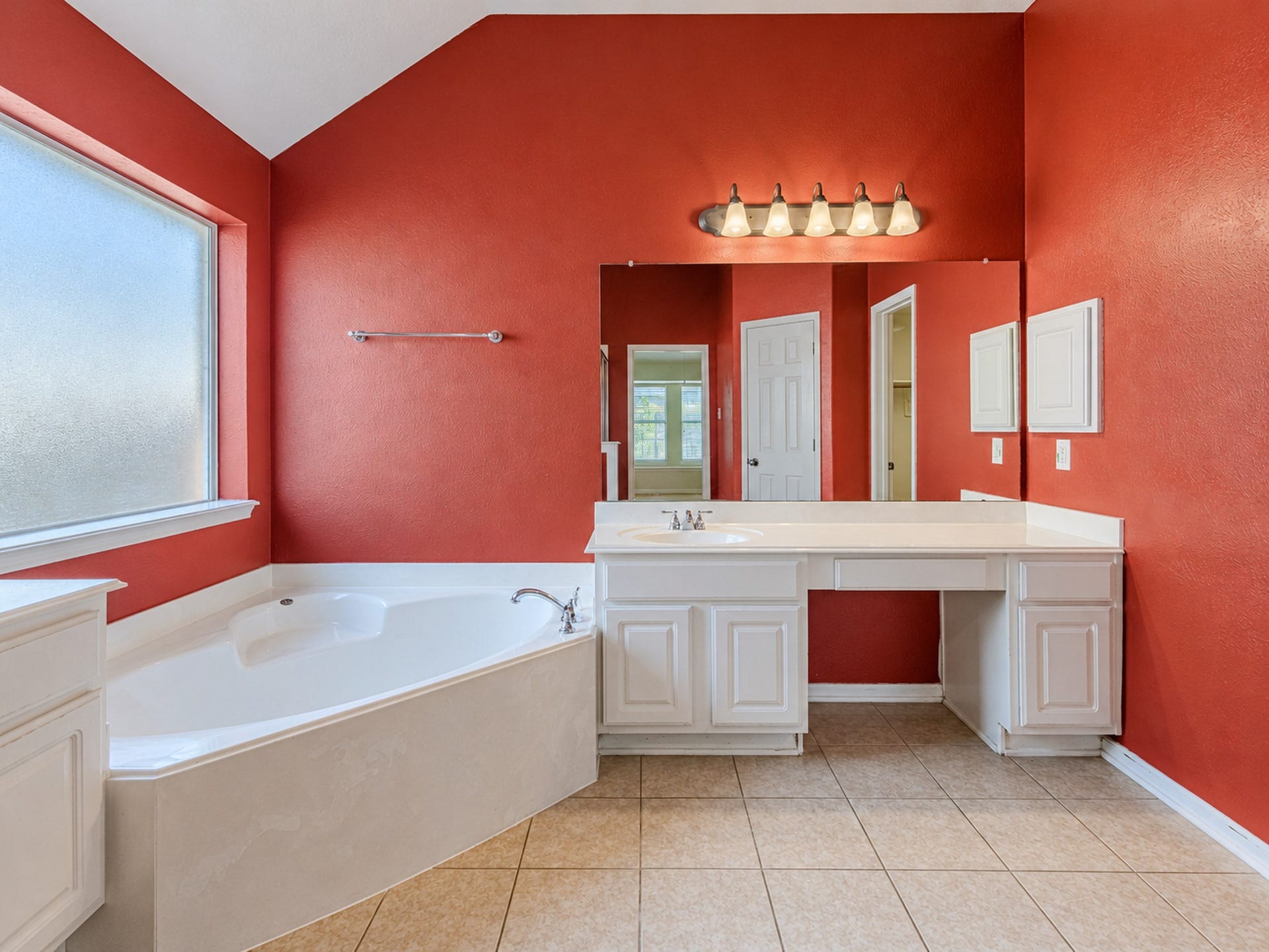 12906 Brook Arbor Court, Pearland, TX 77584 The primary bath includes a vanity with a seated area beside the soaking tub