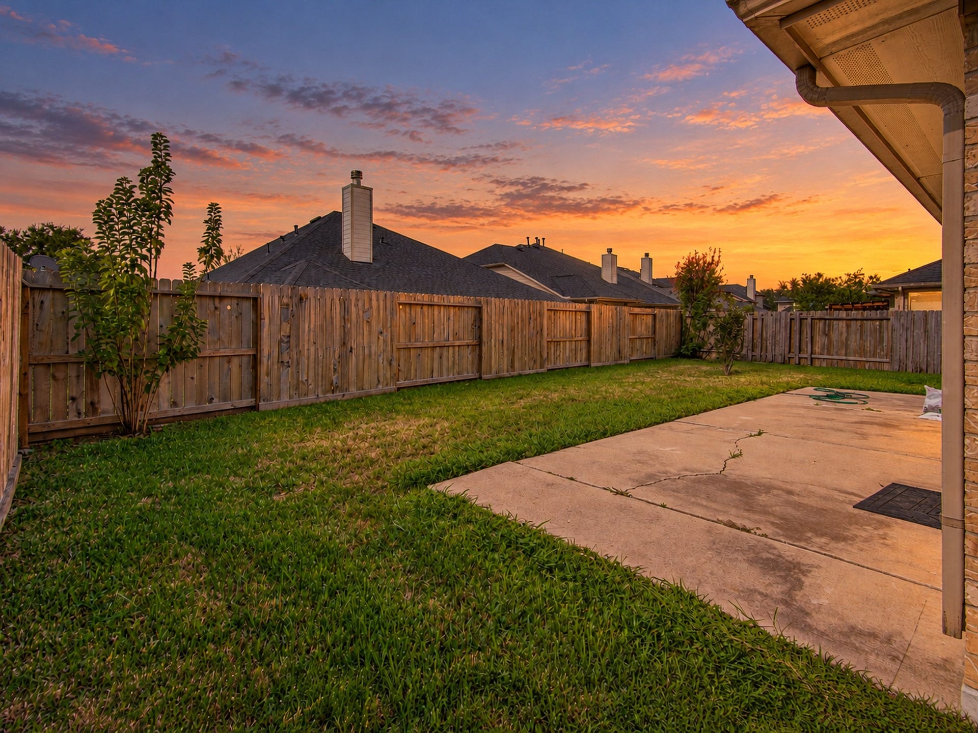 12906 Brook Arbor Court, Pearland, TX 77584 The fenced backyard combines lawn space with a patio for outdoor enjoyment
