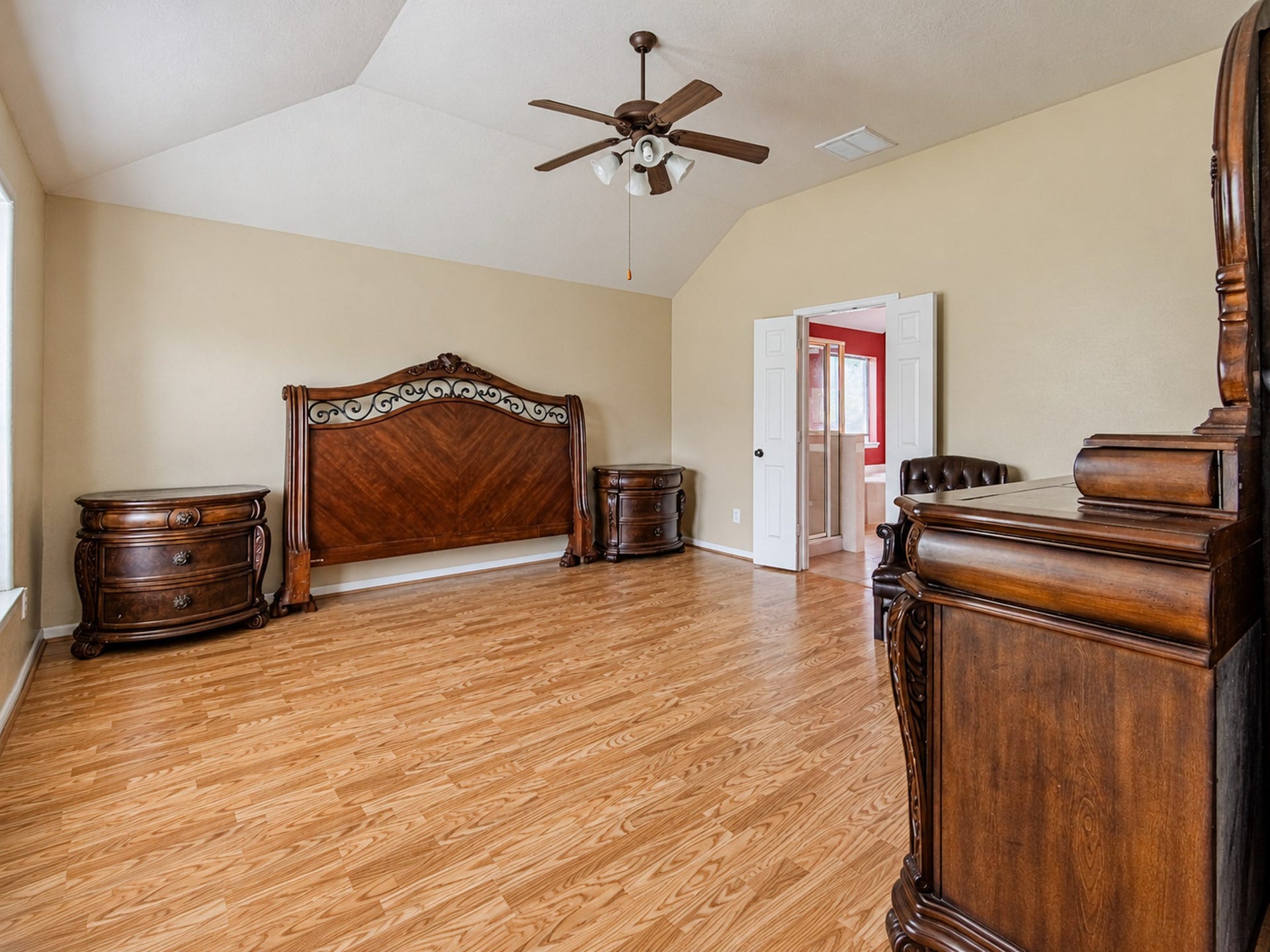 12906 Brook Arbor Court, Pearland, TX 77584 The spacious primary bedroom features wood-look flooring and a ceiling fan