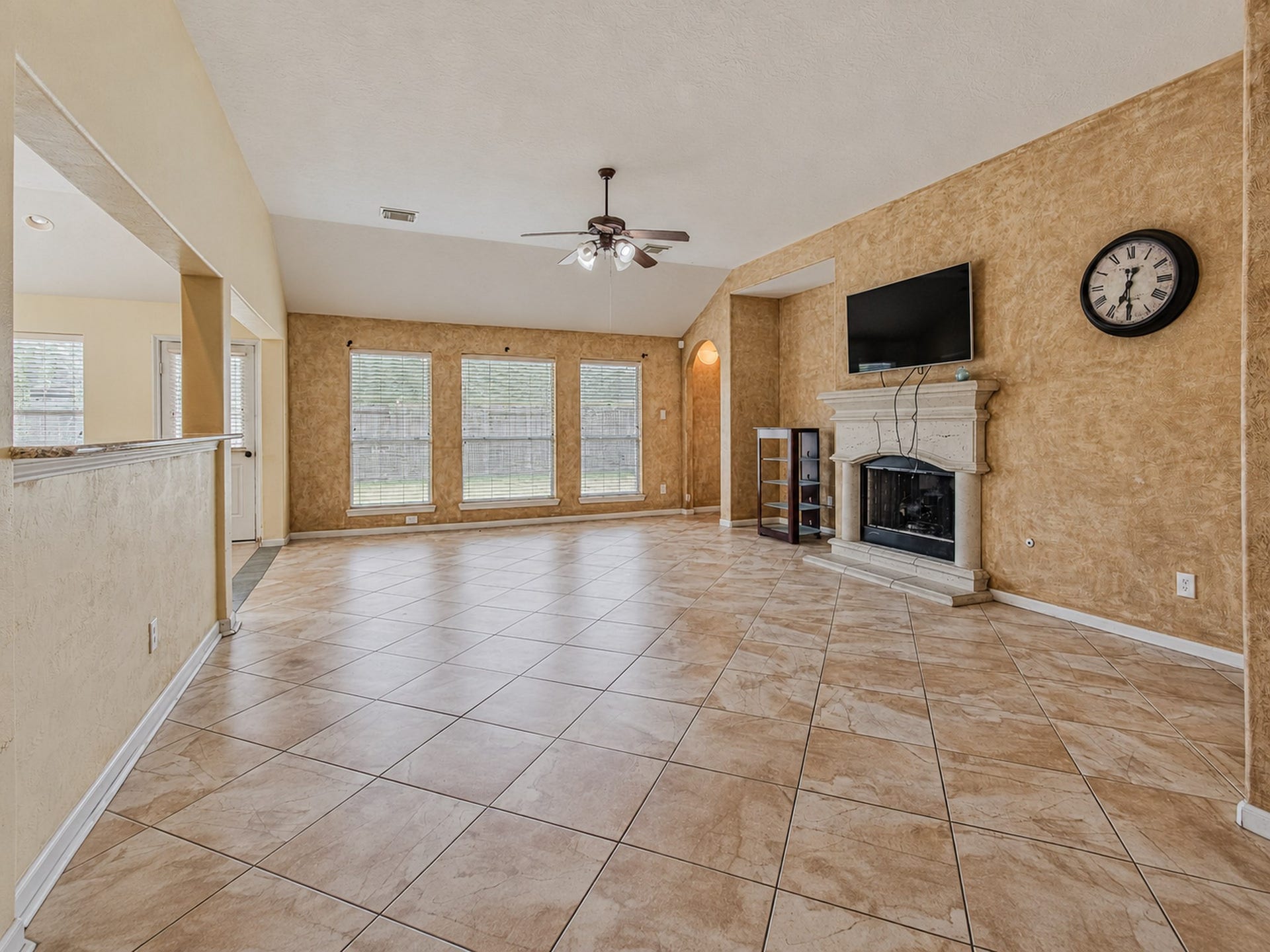 12906 Brook Arbor Court, Pearland, TX 77584 A fireplace anchors the living room, while backyard-facing windows bring in natural light