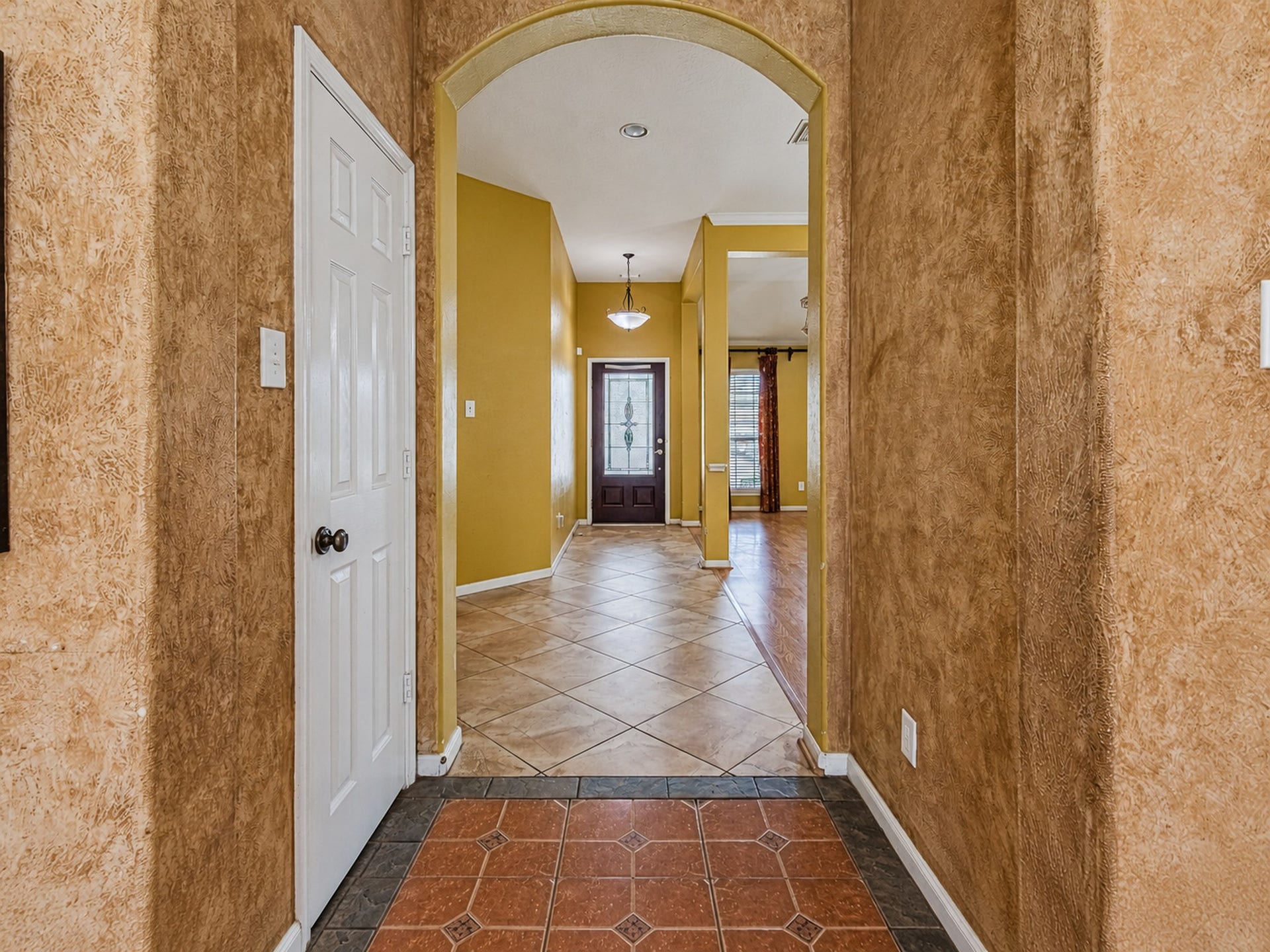 12906 Brook Arbor Court, Pearland, TX 77584 An inviting entryway with tile flooring and an arched opening leads into the home
