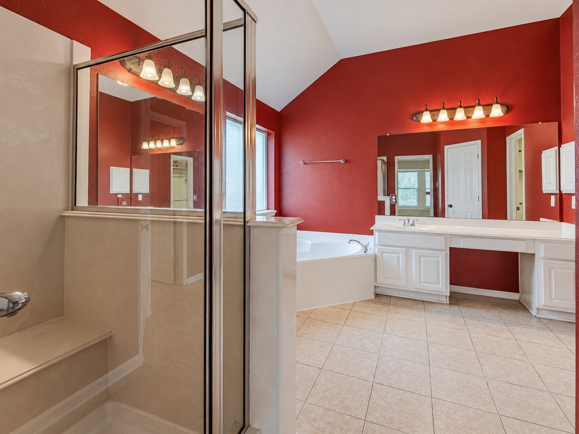 12906 Brook Arbor Court, Pearland, TX 77584 The primary bath features a separate glass-enclosed shower, soaking tub, and two vanity areas