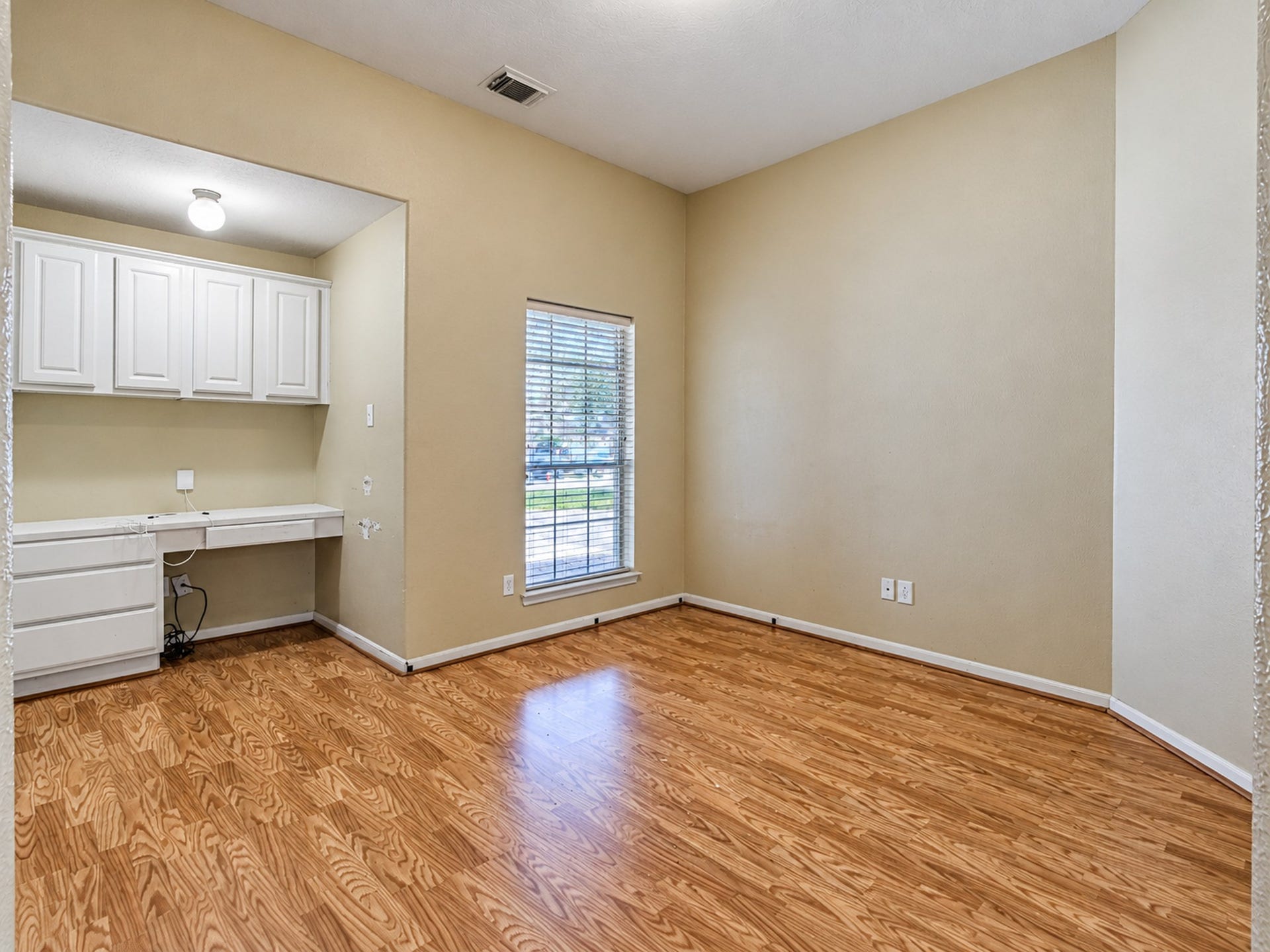 12906 Brook Arbor Court, Pearland, TX 77584 An upstairs common area features wood-look flooring and a built-in desk with shelving