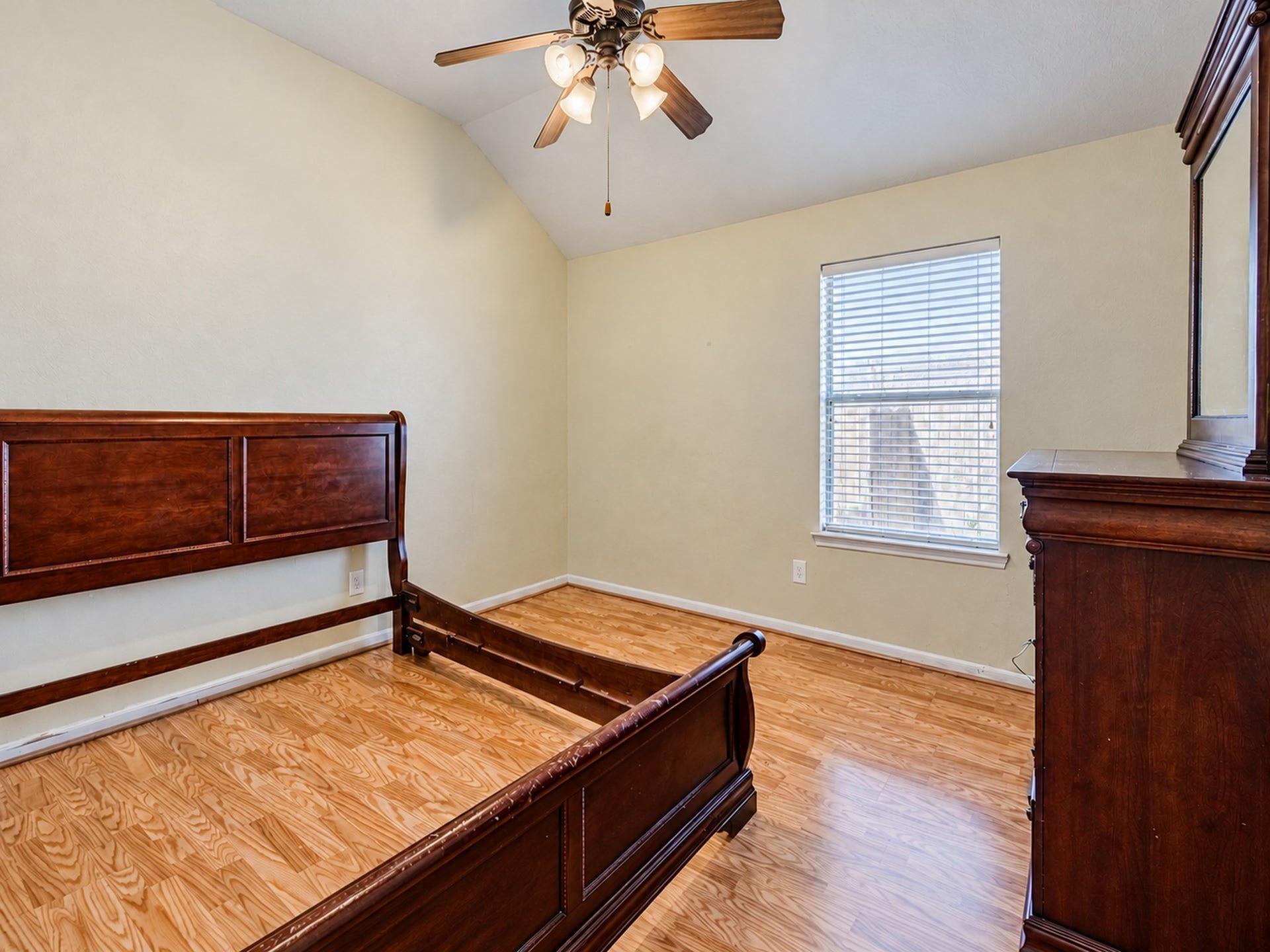 12906 Brook Arbor Court, Pearland, TX 77584 An additional bedroom features wood-look flooring, a ceiling fan, and a window