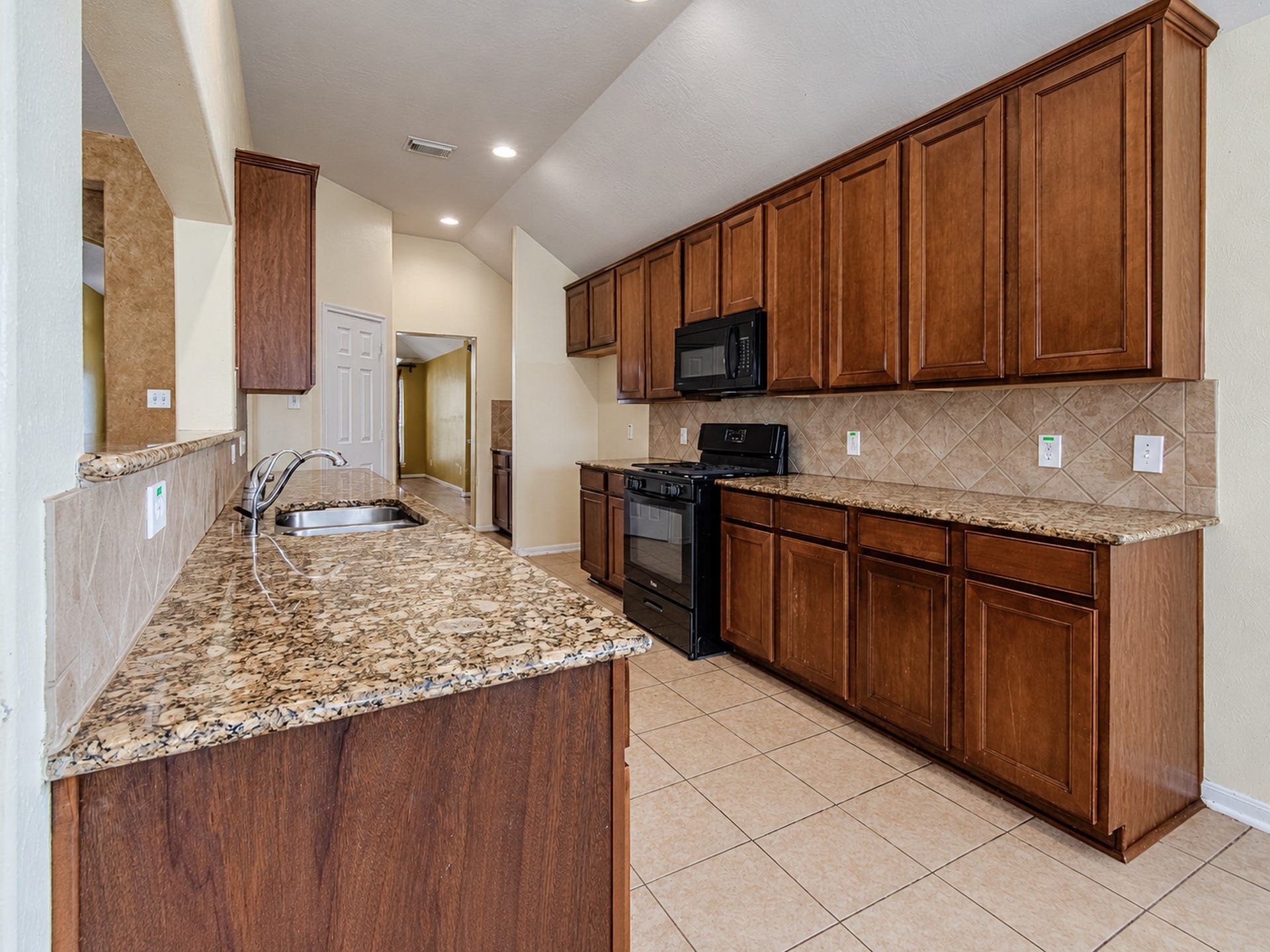 12906 Brook Arbor Court, Pearland, TX 77584 The kitchen features ample cabinetry, generous counter space, and recessed lighting