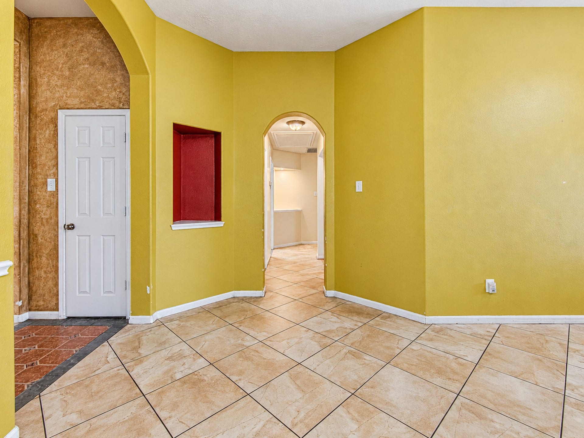 12906 Brook Arbor Court, Pearland, TX 77584 Arched openings and tile flooring connect the home's interior spaces
