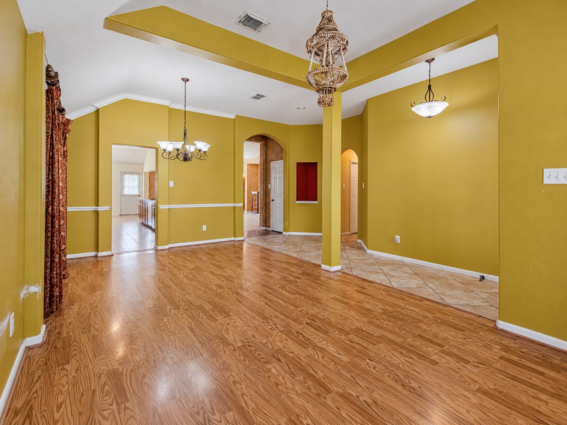 12906 Brook Arbor Court, Pearland, TX 77584 A tray ceiling and arched openings add character to the formal dining area