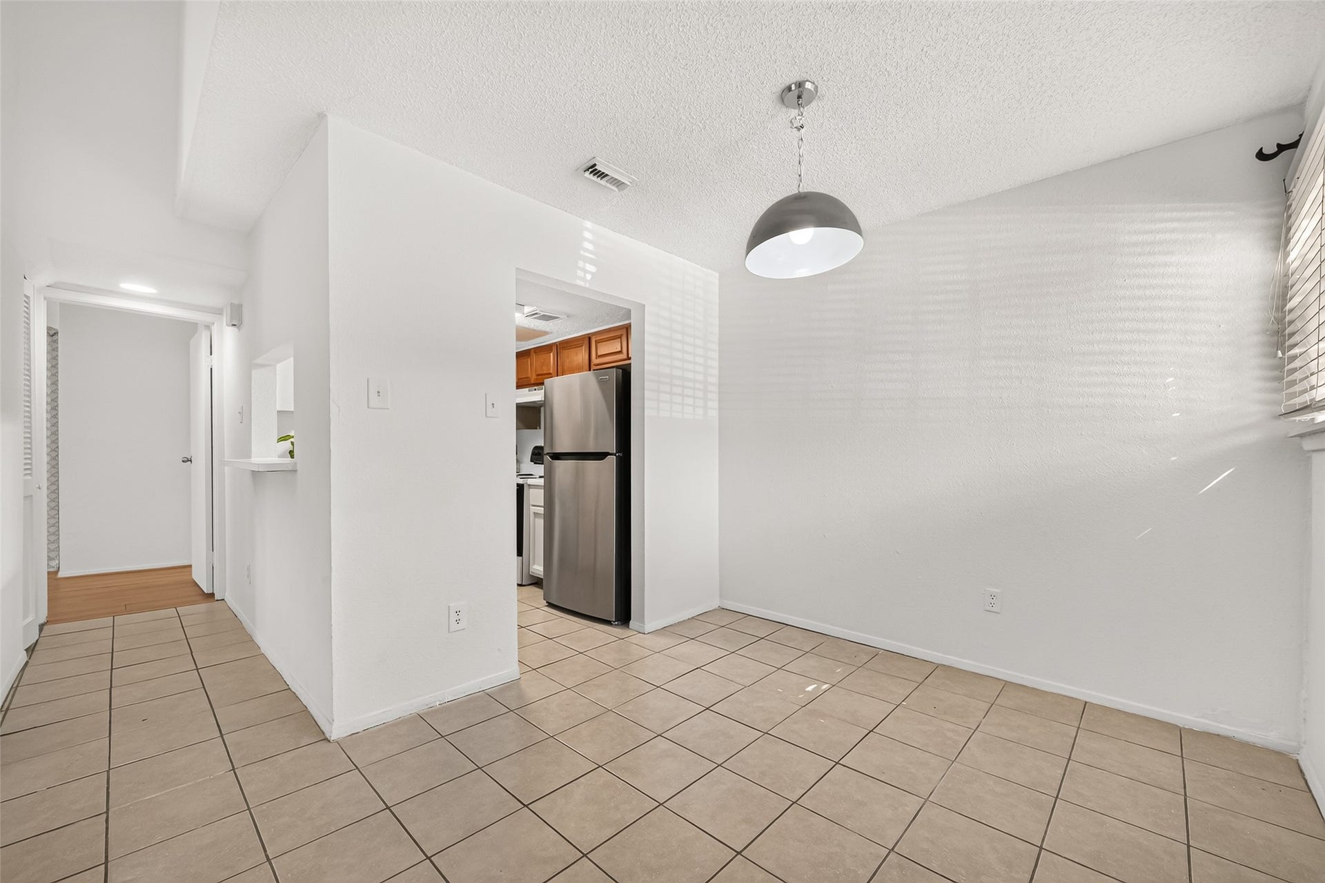 9523 Pagewood Lane, #9523, Houston, TX 77063 Another view from dining to kitchen and hall to the primary bedroom.