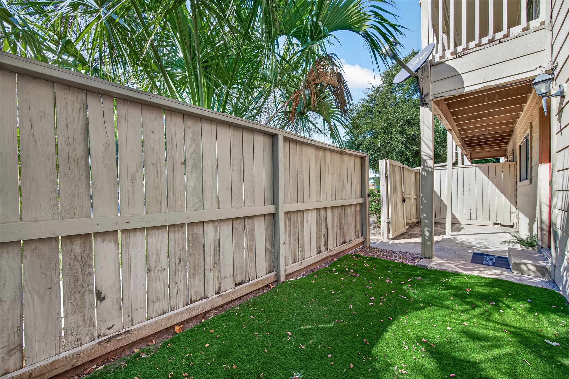 9523 Pagewood Lane, #9523, Houston, TX 77063 fully fenced front porch artificial turf for added convenience, easy maintenance, and a clean, inviting outdoor space.