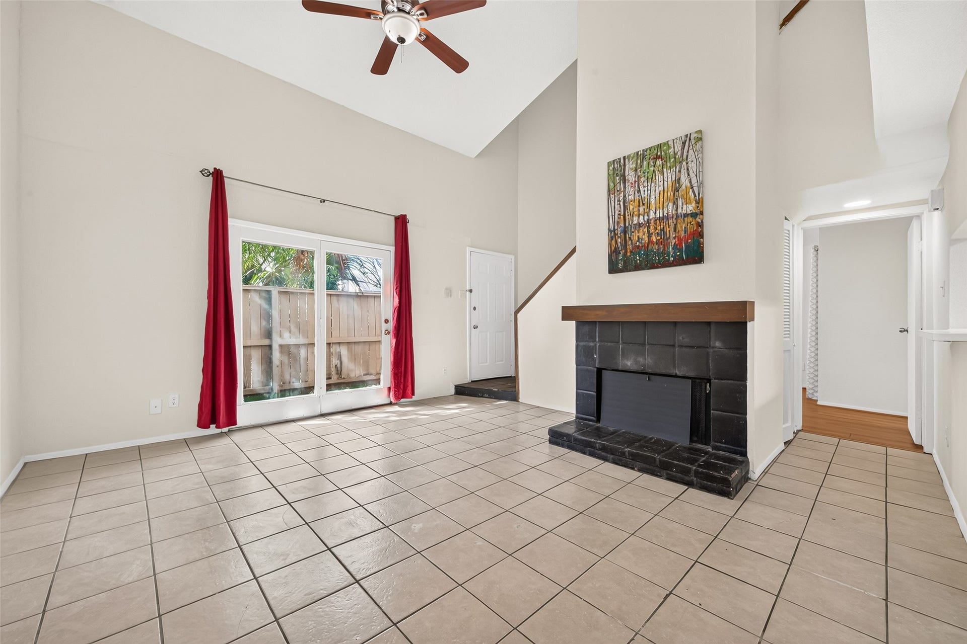 9523 Pagewood Lane, #9523, Houston, TX 77063 Spacious living area with high ceilings, featuring a cozy fireplace.