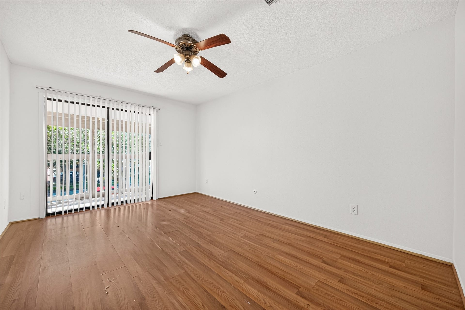 9523 Pagewood Lane, #9523, Houston, TX 77063 Secondary primary bedroom Bedroom with abundant natural light & sliding glass door leading to a balcony.