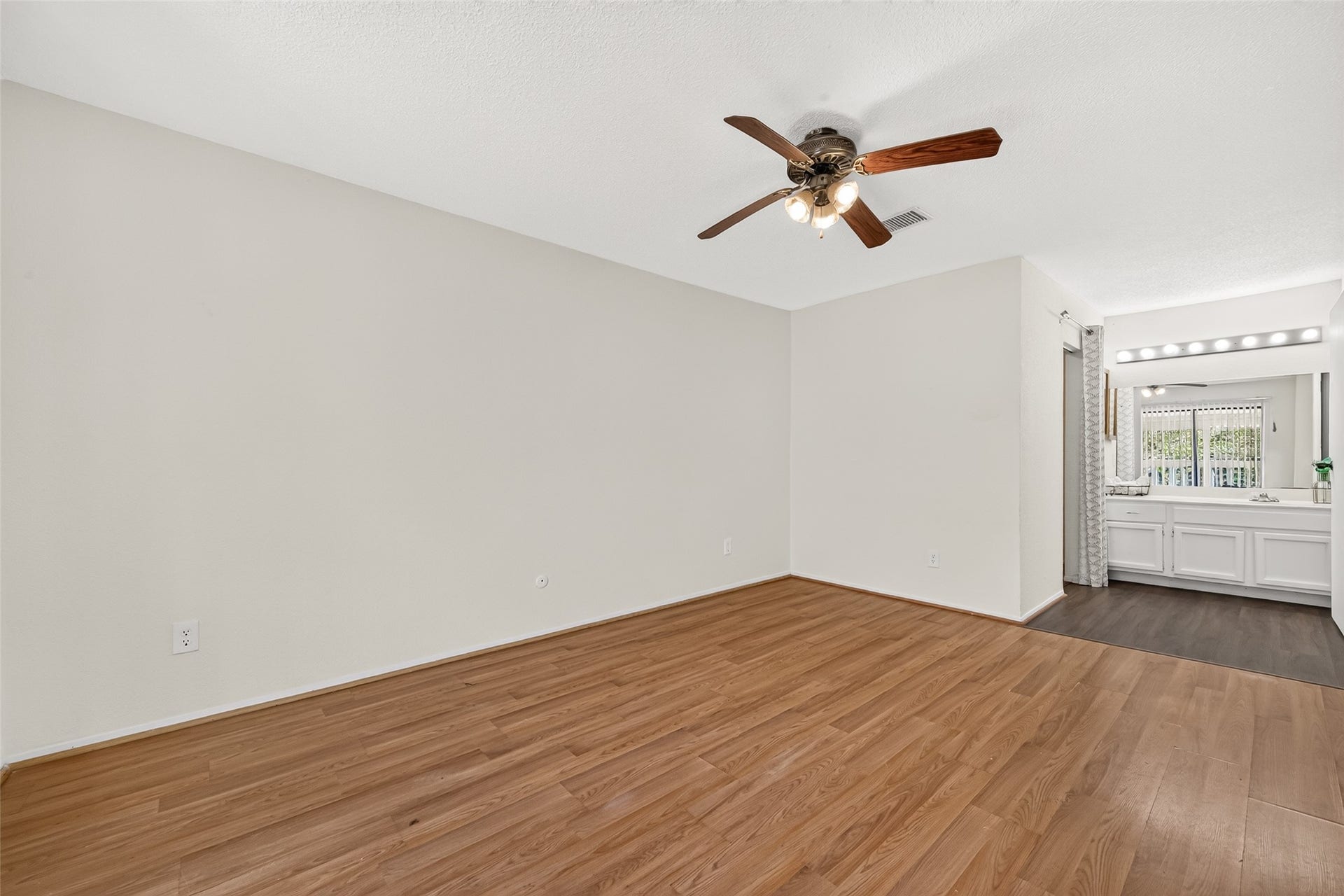 9523 Pagewood Lane, #9523, Houston, TX 77063 A view of the secondary primary bedroom leading to Bright Vanity area tothe left a walk in closet and the the right a tubshower combination, offering both style & functionality.