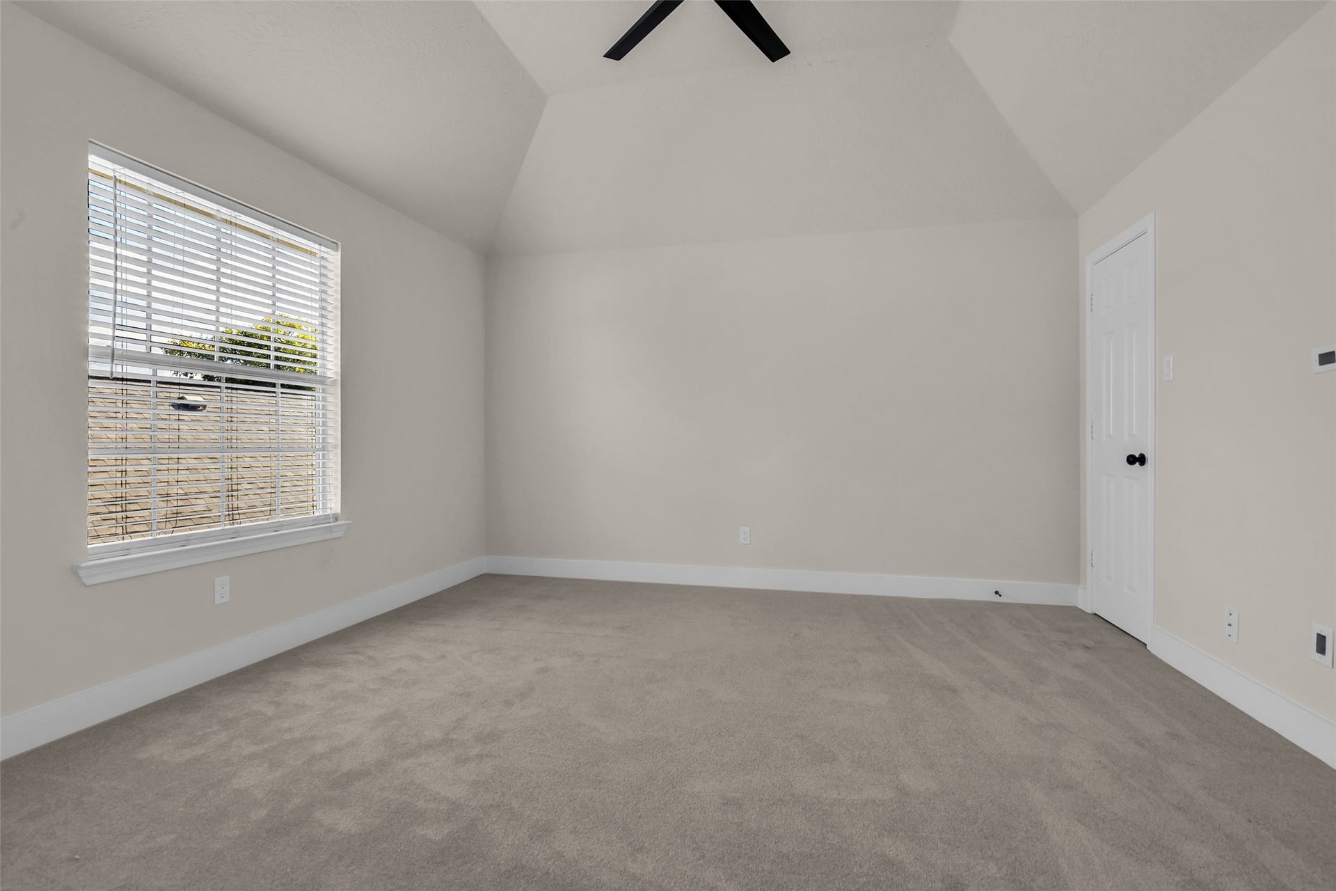 6110 Four River Drive, Richmond, TX 77469 Next bedroom with high ceilings, neutral walls, and soft carpet, featuring a large window that allows natural light to fill the space.