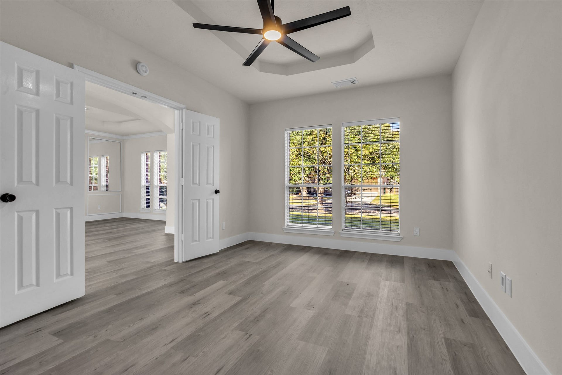 6110 Four River Drive, Richmond, TX 77469 Den/study area with large windows, modern ceiling fan, and elegant double doors.