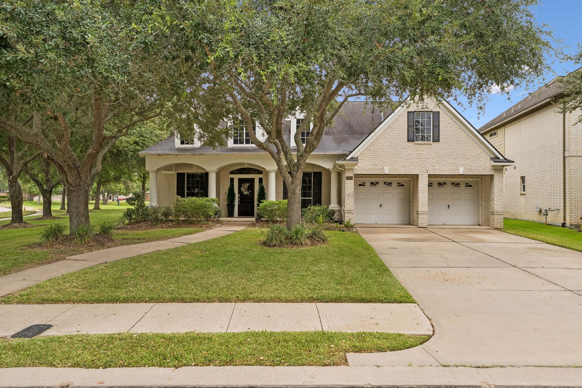 13050 Forester Canyon Lane, Sugar Land, TX 77498 Charming 1.5-story home with a welcoming front porch, mature trees, and a spacious two-car garage.