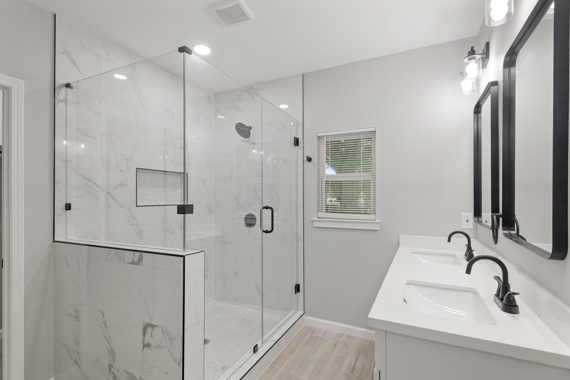 The expansive walk-in shower, adorned sleek glass front, offers a luxurious escape for a quick rinse or a refreshing retreat.