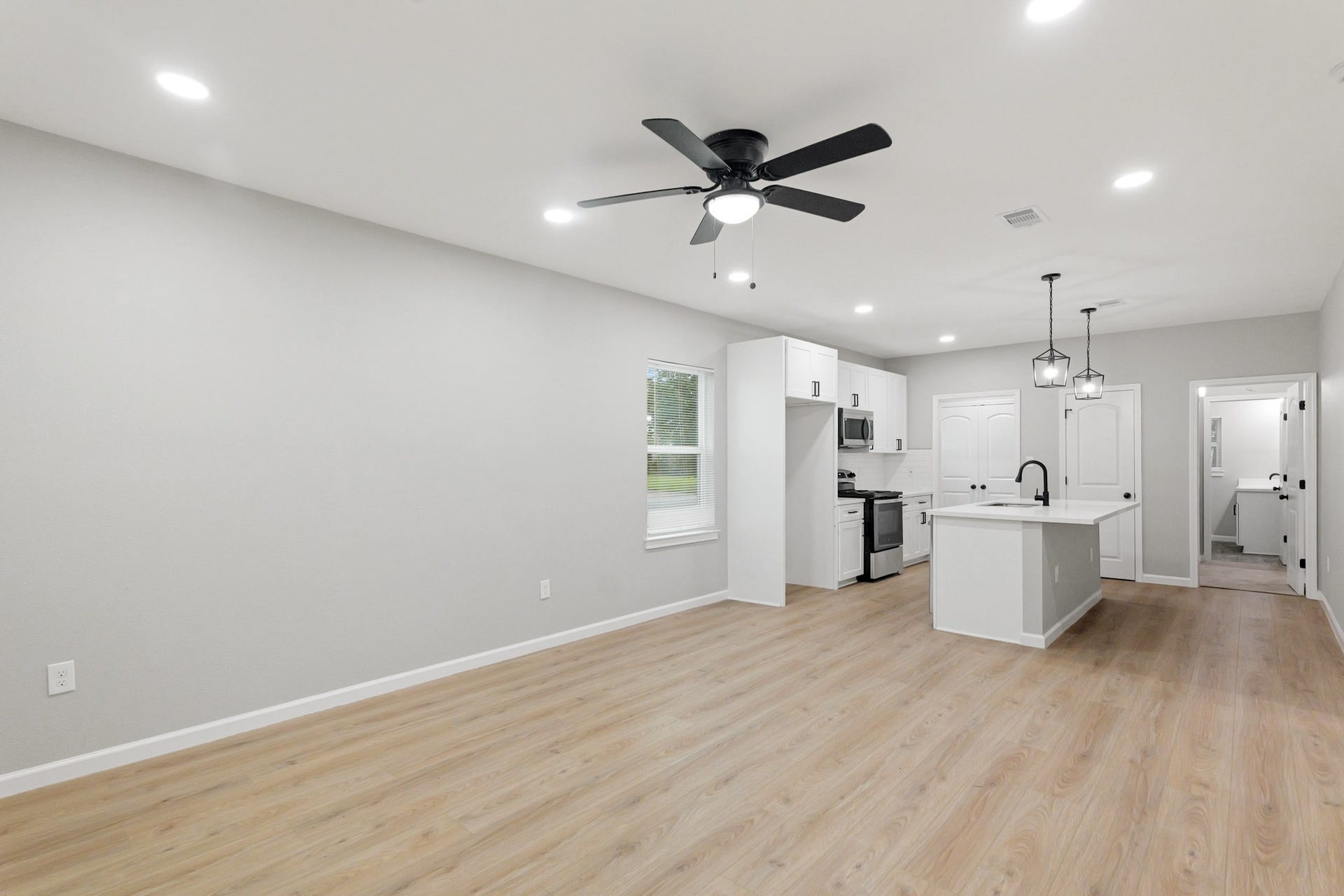Durable and stylish vinyl plank flooring welcomes you into the open-concept living and kitchen area, combining comfort with modern appeal.