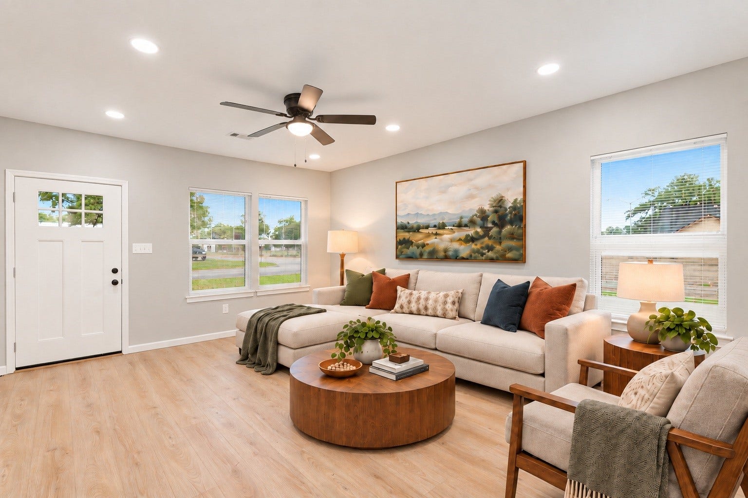 The living area is flooded with natural light, creating a bright and airy atmosphere that invites relaxation and warmth. Virtually staged.