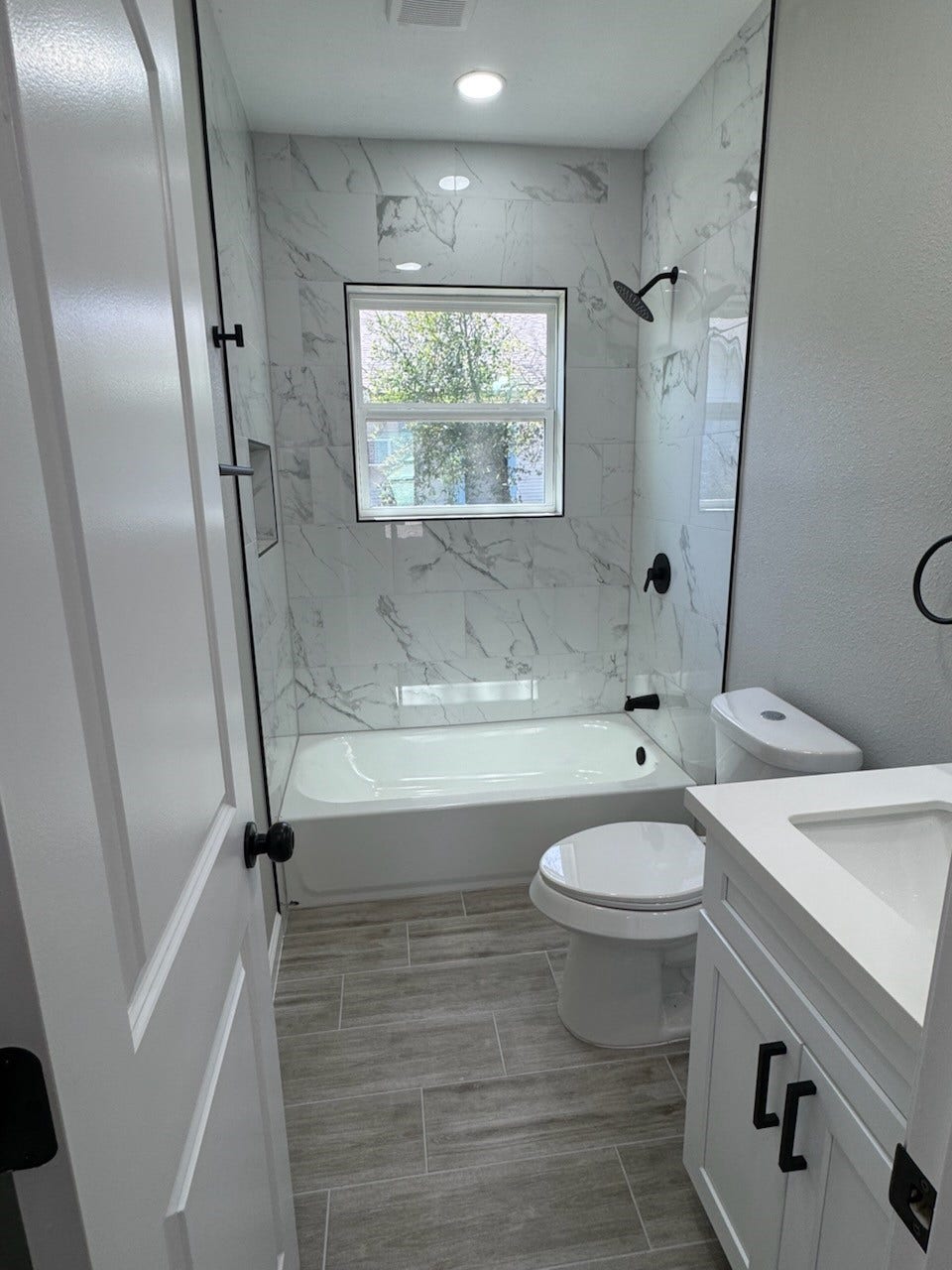 Beautifully updated secondary bathroom featuring a sleek tub/shower combo, perfect for both quick rinses and relaxing soaks.