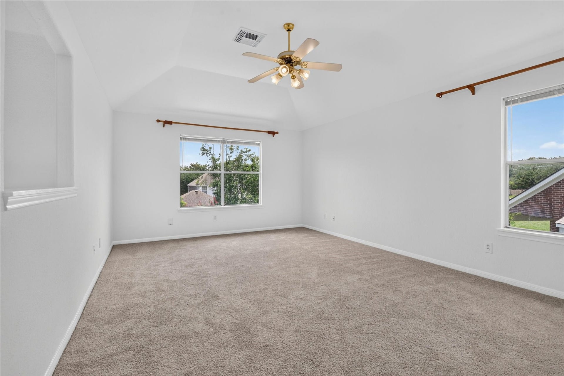 4610 Misty Morning Court, Missouri City, TX 77459 This spacious, carpeted Gameroom features neutral walls, a ceiling fan, and abundant natural light from two large windows with scenic views.