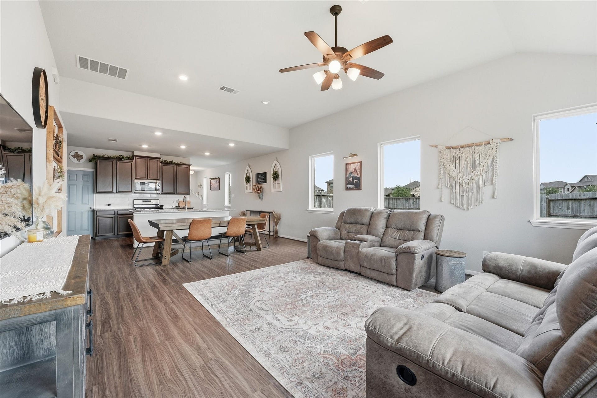 2130 Shellbark Way, La Marque, TX 77568 The living room is cozy with plush seating and natural light from large windows. The neutral tones a create a warm, inviting atmosphere.