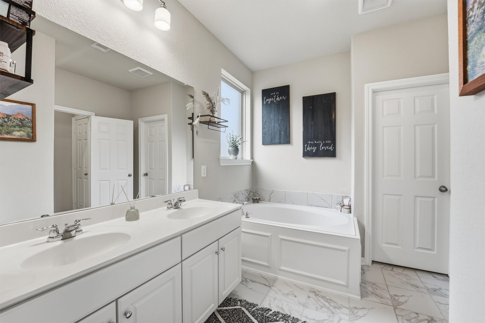 2130 Shellbark Way, La Marque, TX 77568 Primary bathroom features a double vanity with sleek sinks, a spacious garden tub and large closet.