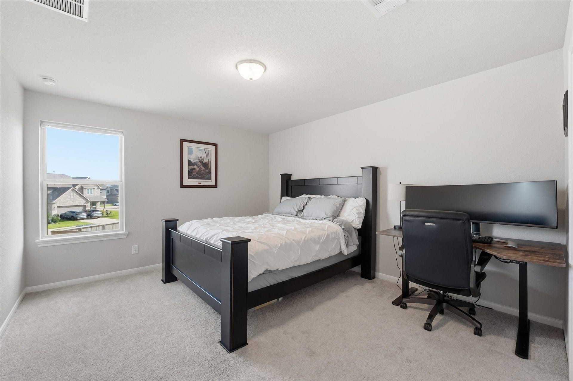2130 Shellbark Way, La Marque, TX 77568 A bright bedroom with a large window offers natural light, large closet and a neighborhood view.