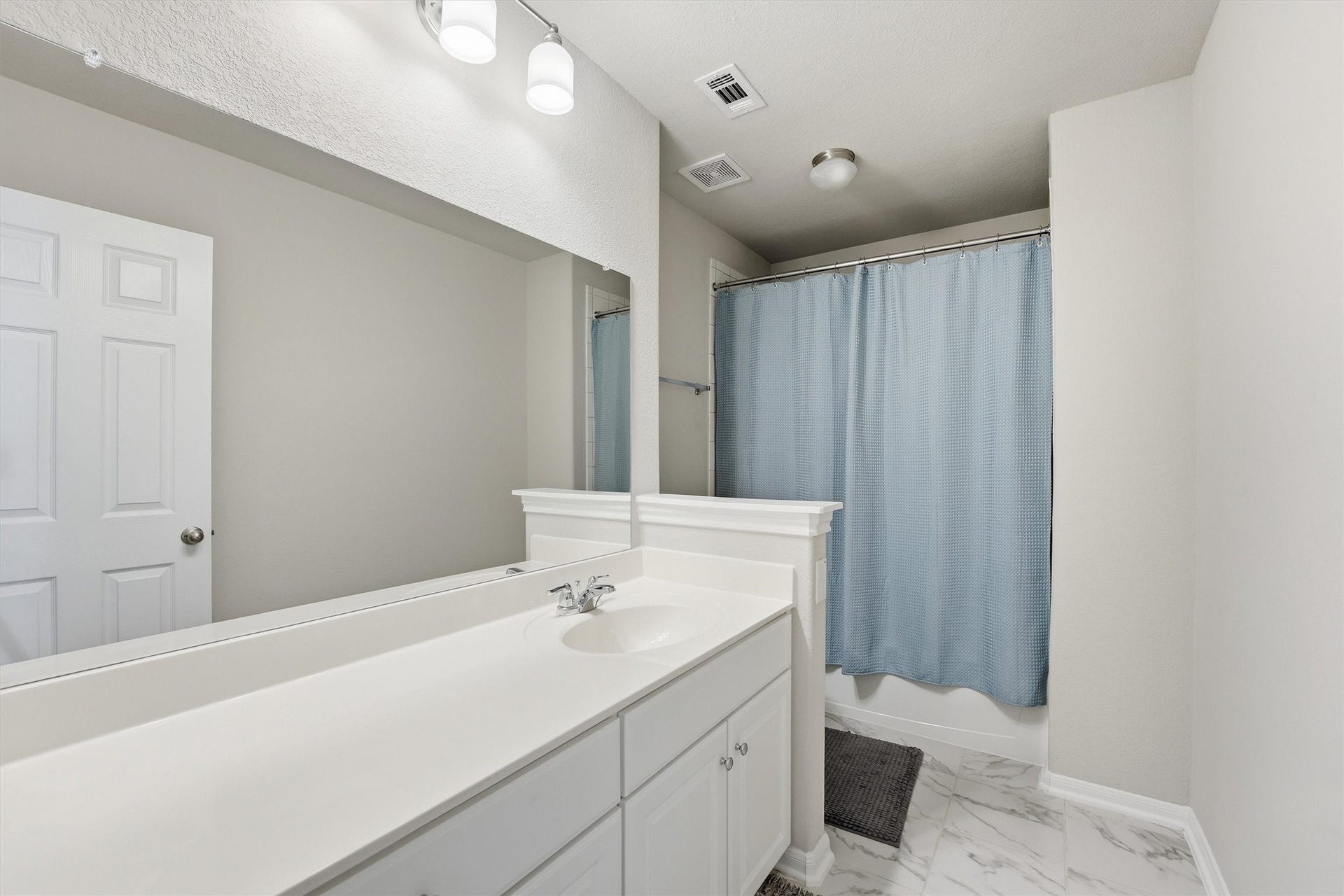 2130 Shellbark Way, La Marque, TX 77568 Secondary bathroom features a clean, modern design with a large mirror, white vanity, shower and tub combo.