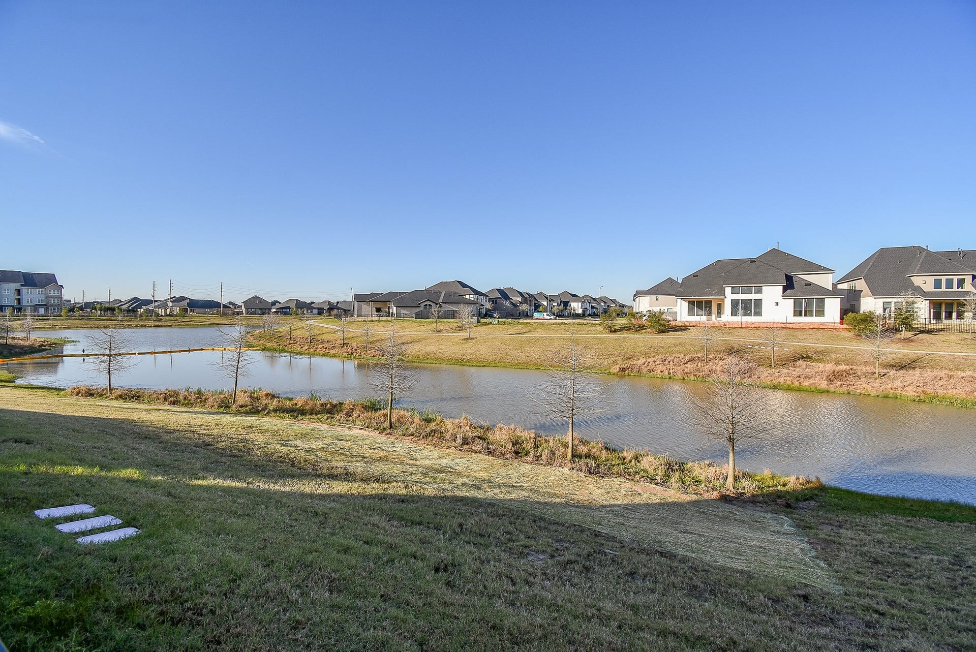 A larger beautiful water view of the community and a lake.