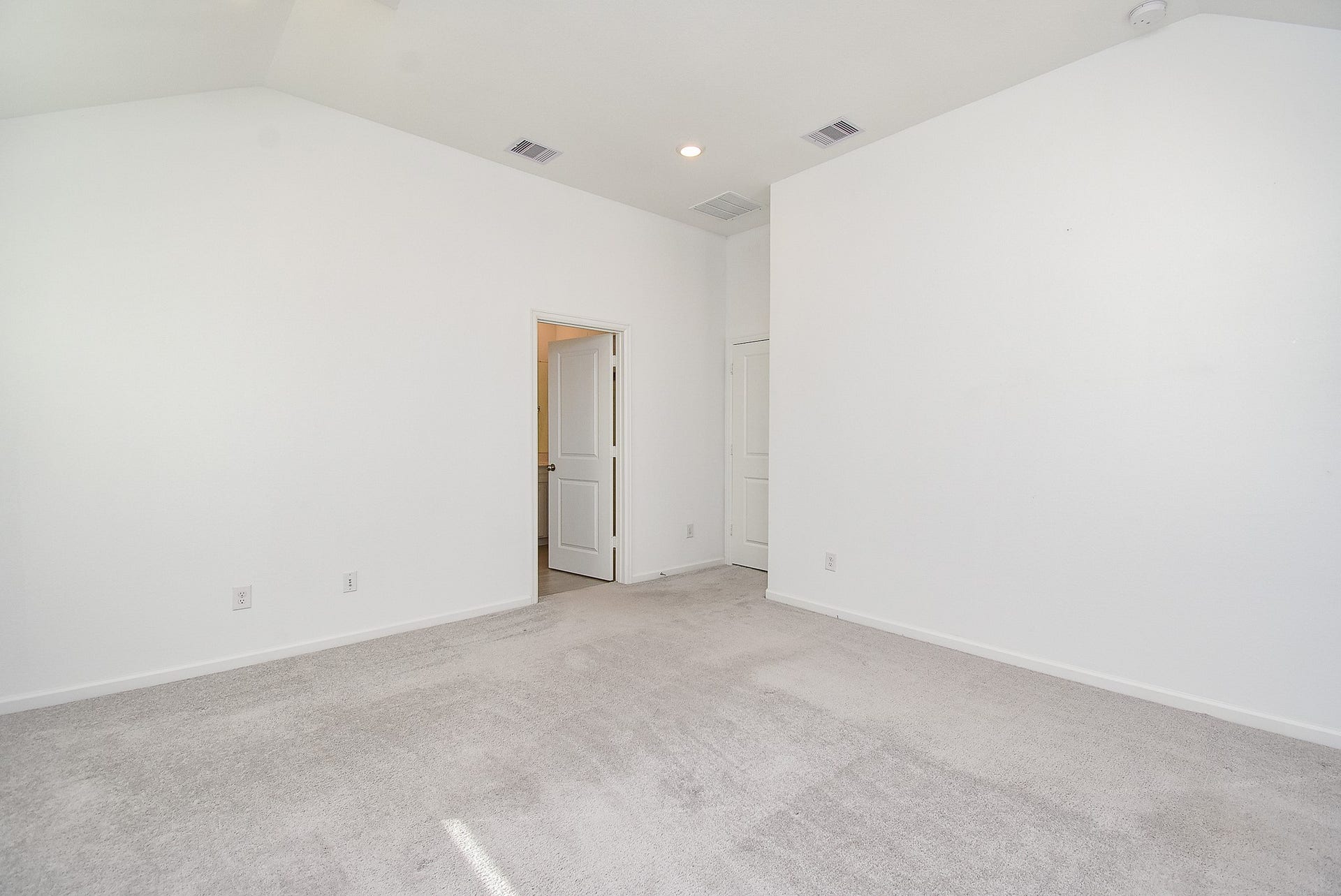 A reverse view of the primary bedroom with easy access to the ensuite bathroom
