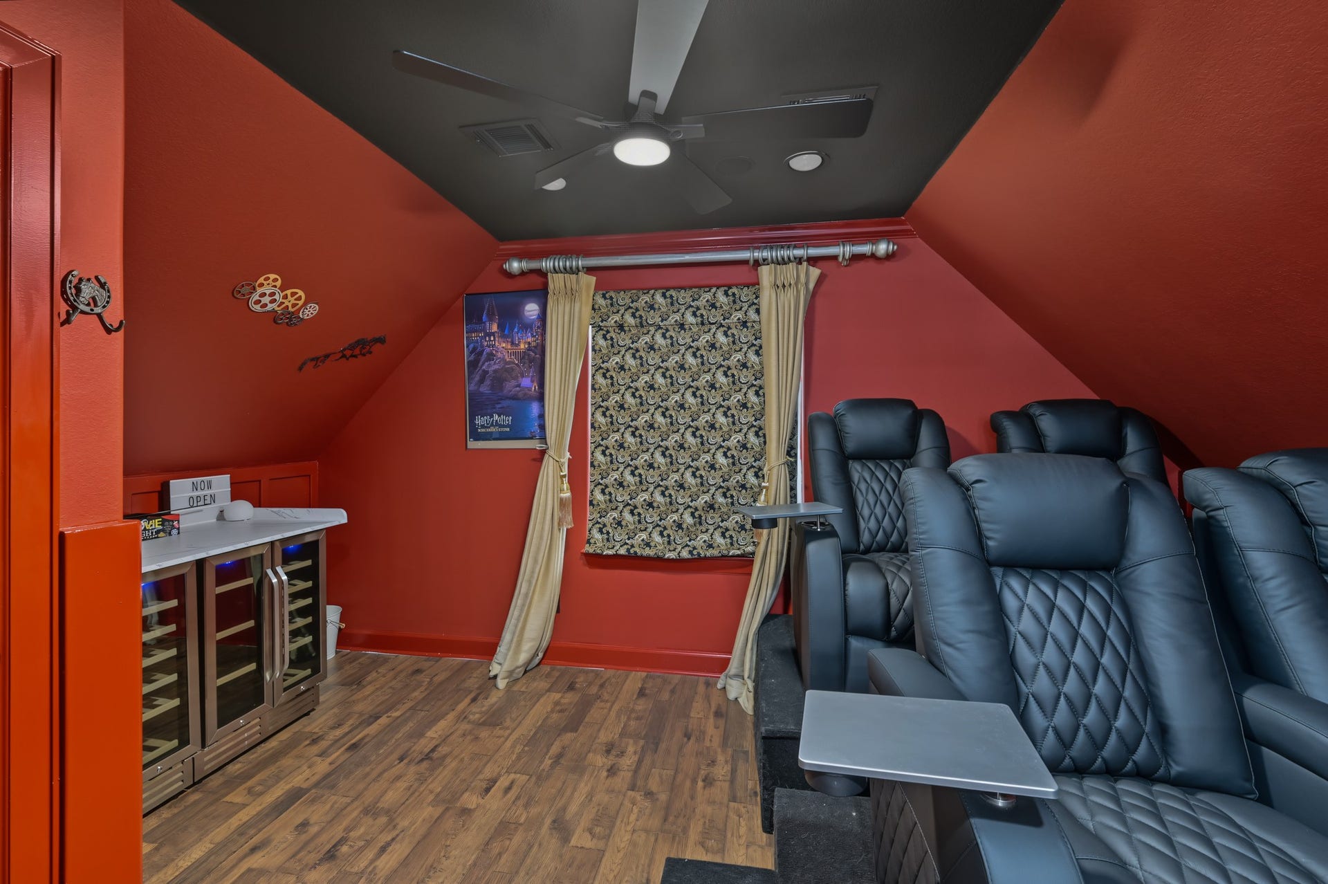 Experience cinematic luxury in this vibrant home theater, featuring plush reclining seats, classic movie posters, and a cozy ambiance perfect for entertainment. Complete with a projection system, surround sound speakers, and mini fridge, snack bar, soda stream, and popcorn machine ready for all your entertainment needs!