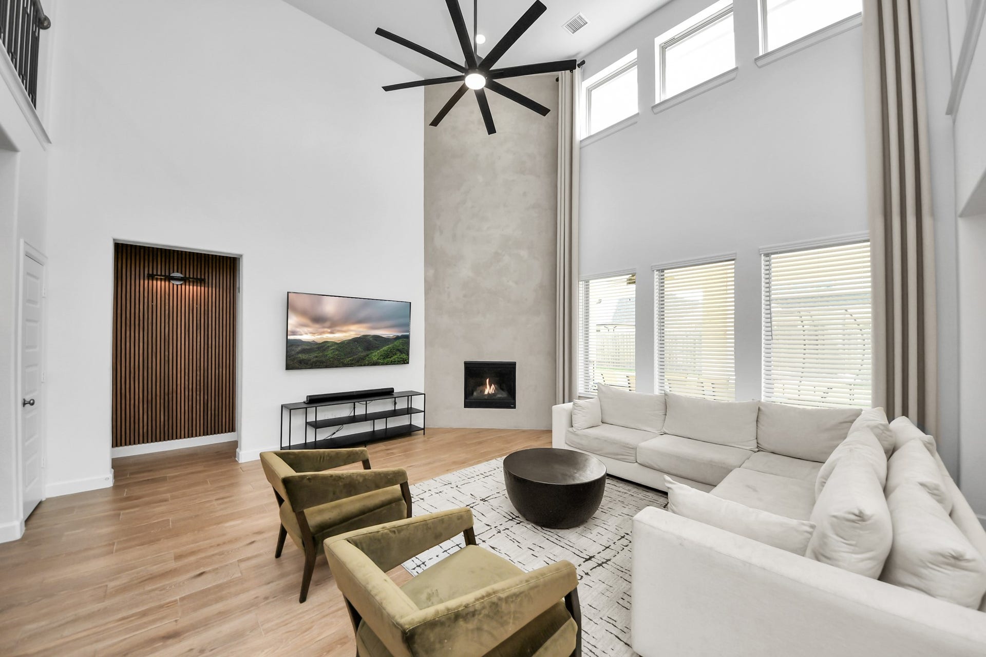 5542 Fairfield Lane, Pasadena, TX 77505 Spacious and modern living room with high ceilings, a sleek fireplace, and large windows for abundant natural light.