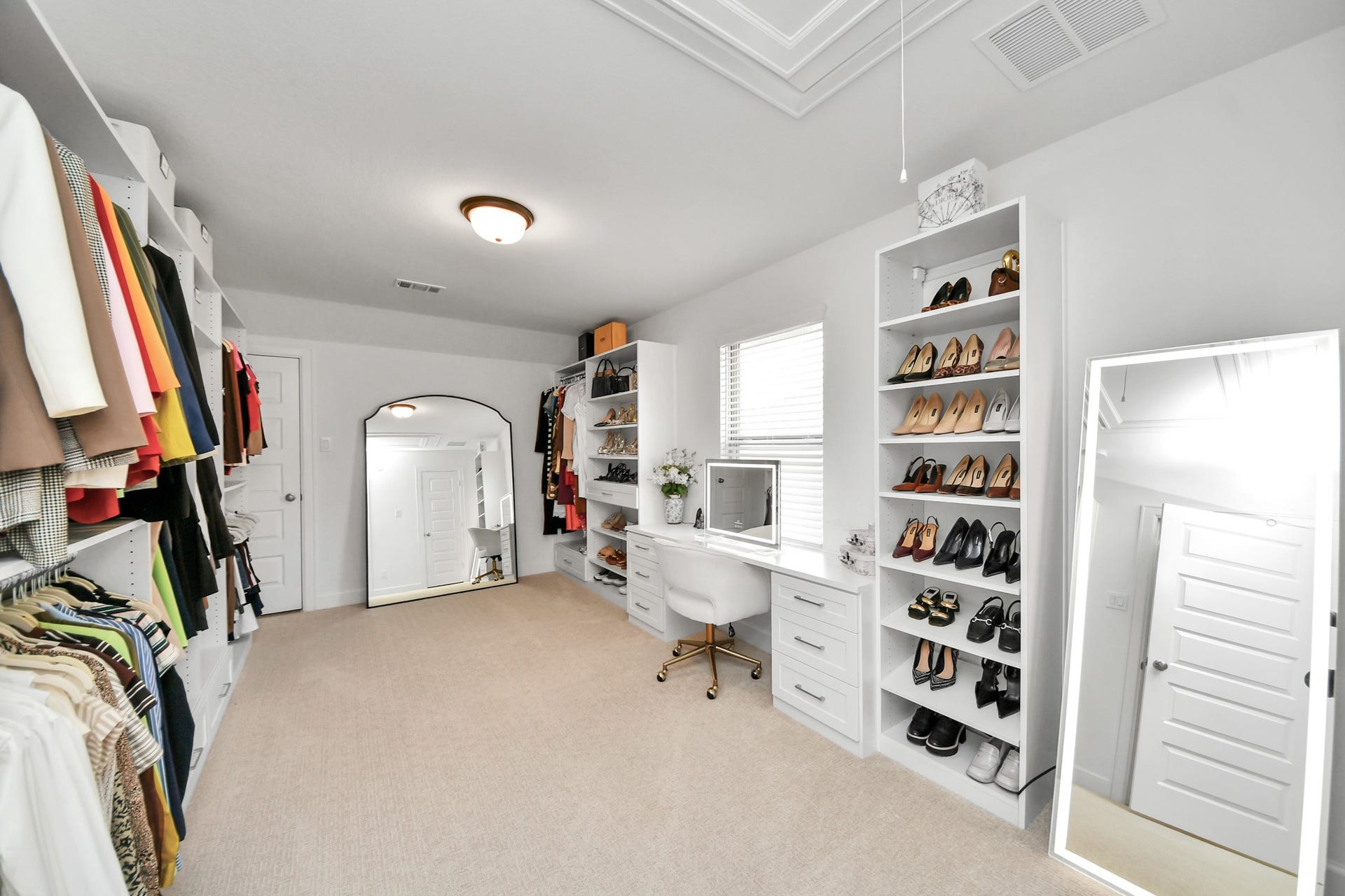 5542 Fairfield Lane, Pasadena, TX 77505 Bedroom converted into a Custom California Closet with built-in shelving, ample hanging space, and a chic vanity area for all your storage and dressing needs.