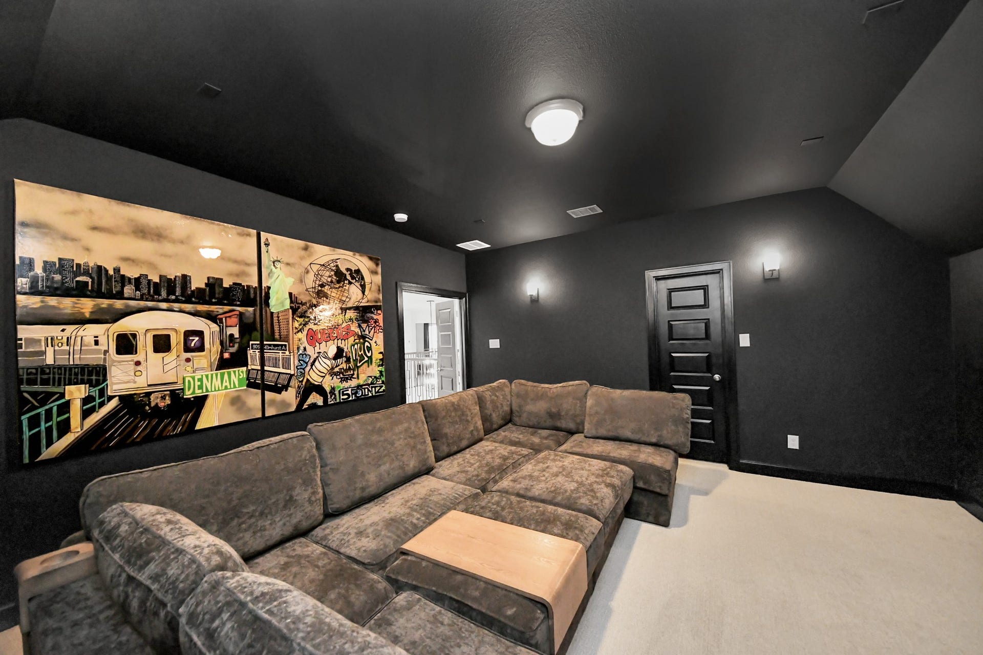 5542 Fairfield Lane, Pasadena, TX 77505 Experience ultimate relaxation in this stylish media room, featuring a plush L-shaped sectional, modern lighting, and vibrant wall art for a cozy entertainment haven.