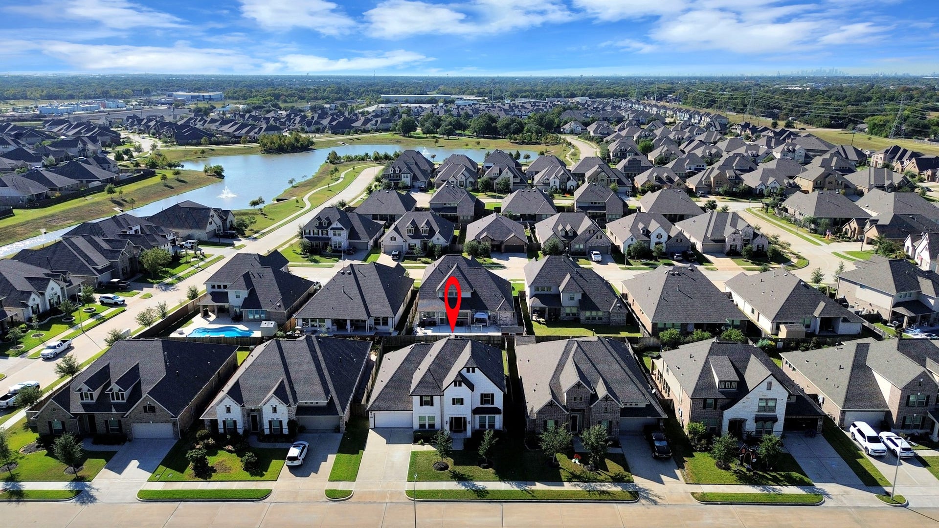 5542 Fairfield Lane, Pasadena, TX 77505 Charming suburban home nestled in a picturesque neighborhood with a serene community lake nearby, offering a tranquil and inviting setting.