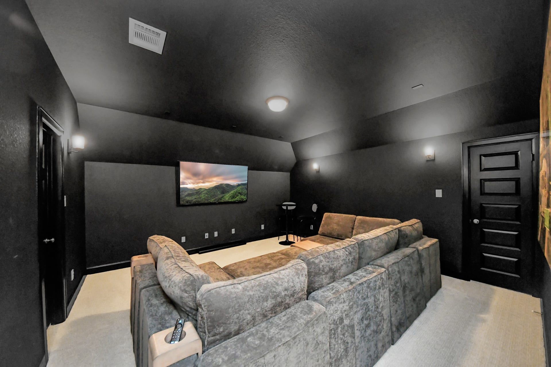 5542 Fairfield Lane, Pasadena, TX 77505 Experience luxury entertainment in this sleek home theater, featuring plush sectional seating, ambient lighting, and a large wall-mounted screen for an immersive viewing experience.