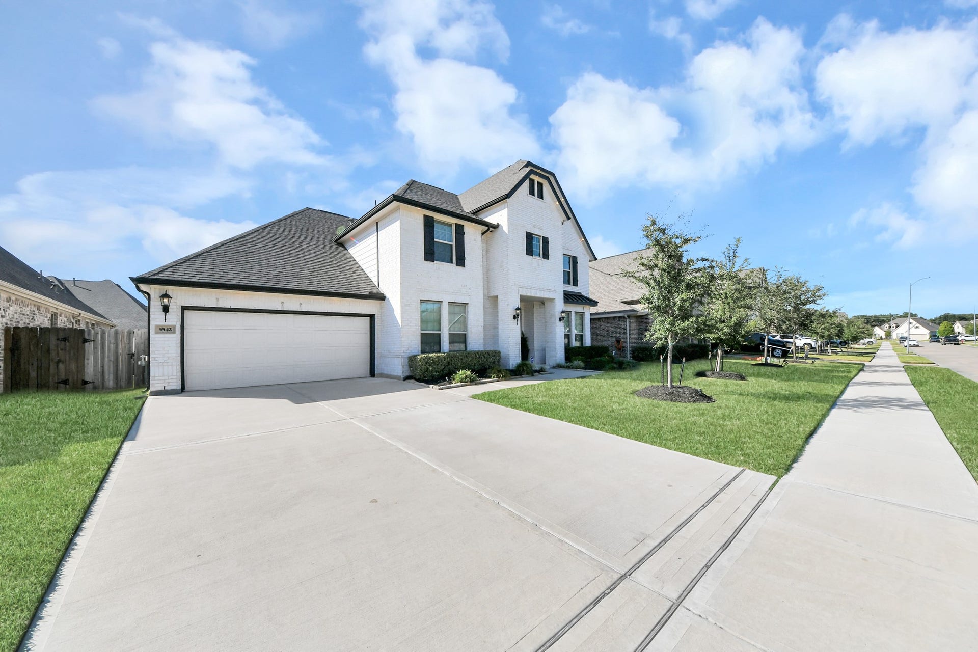 5542 Fairfield Lane, Pasadena, TX 77505 Charming two-story home with a spacious driveway, elegant brick exterior, and manicured landscaping on a peaceful suburban street.