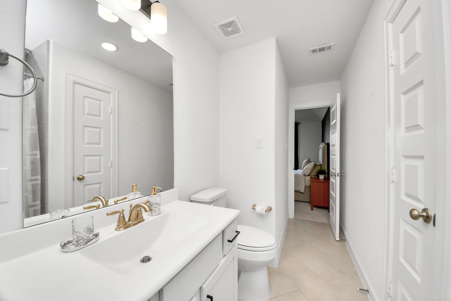 5542 Fairfield Lane, Pasadena, TX 77505 Bright and modern bathroom featuring sleek fixtures, ample lighting, and a seamless connection to the adjacent bedroom.