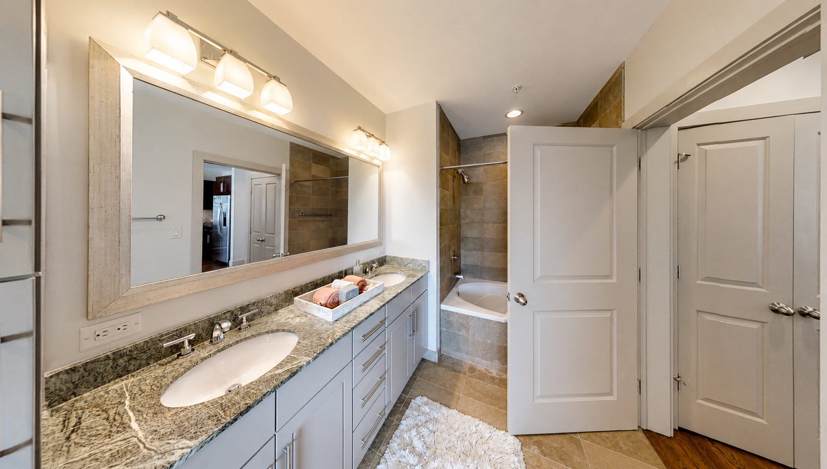 1400 McKinney Street, #2306, Houston, TX 77010 The primary bath gives you plenty of room to get ready comfortably, with dual sinks, generous counter space and a separate tub and shower.